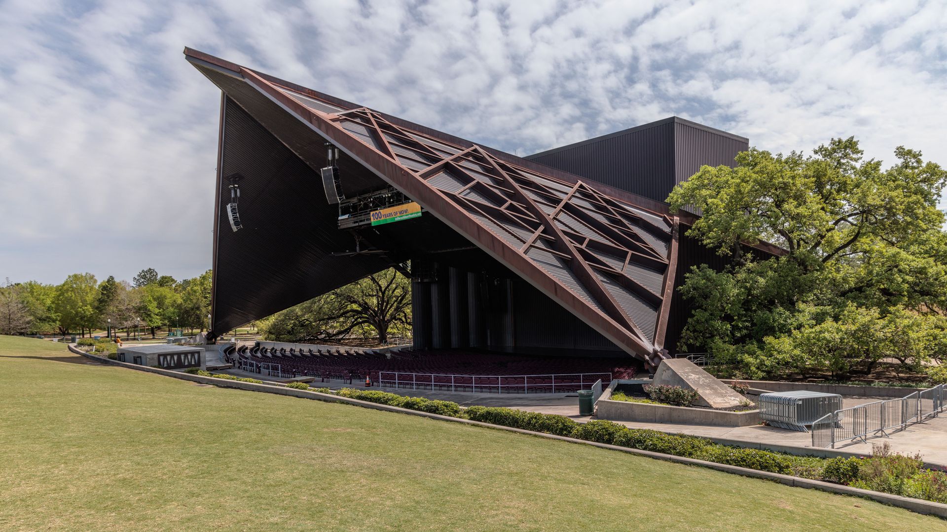 Photo of an outdoor theater with a geometric tent roof. 