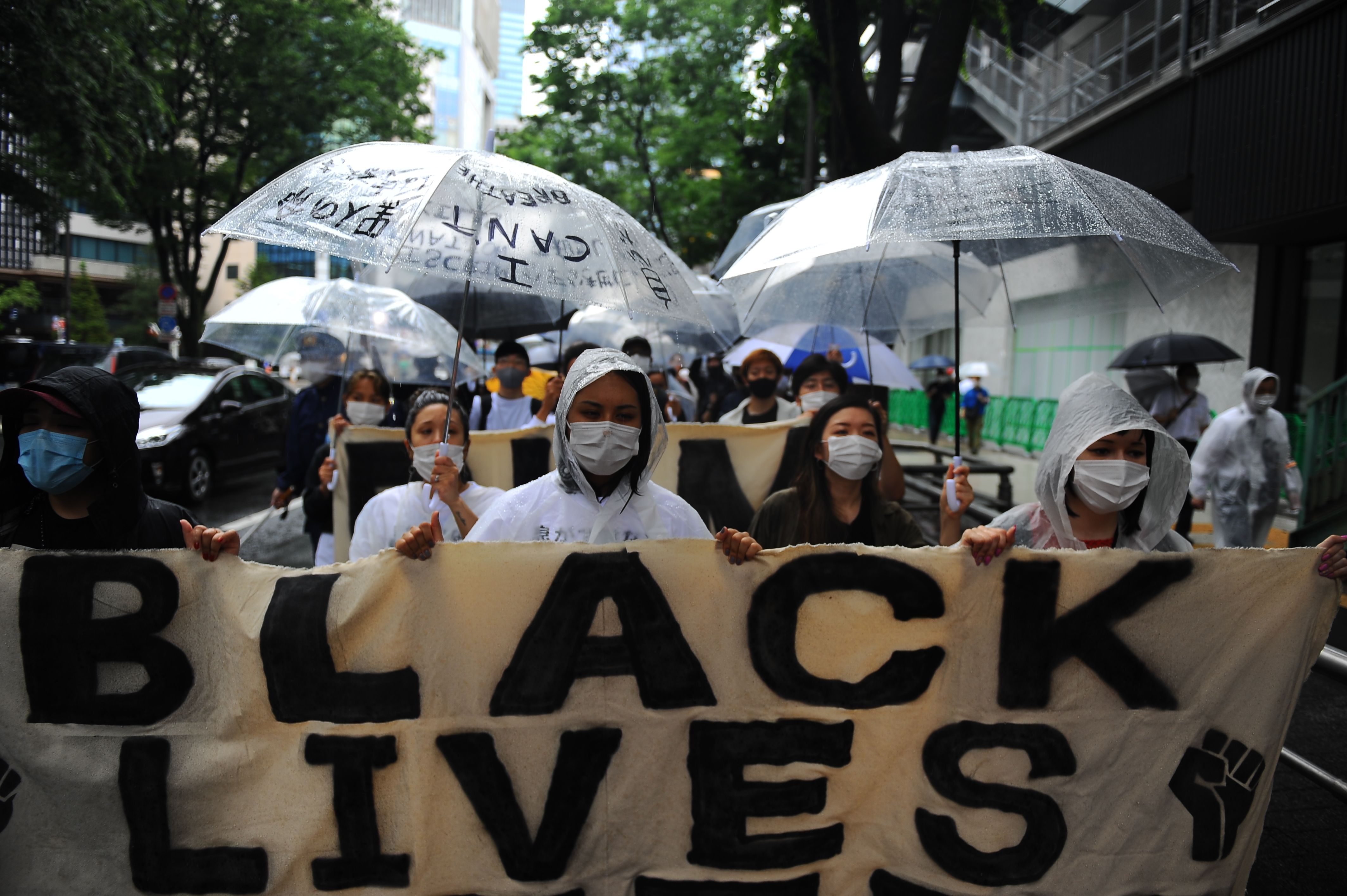 A Black Lives Matter banner is carried in Tokyo 