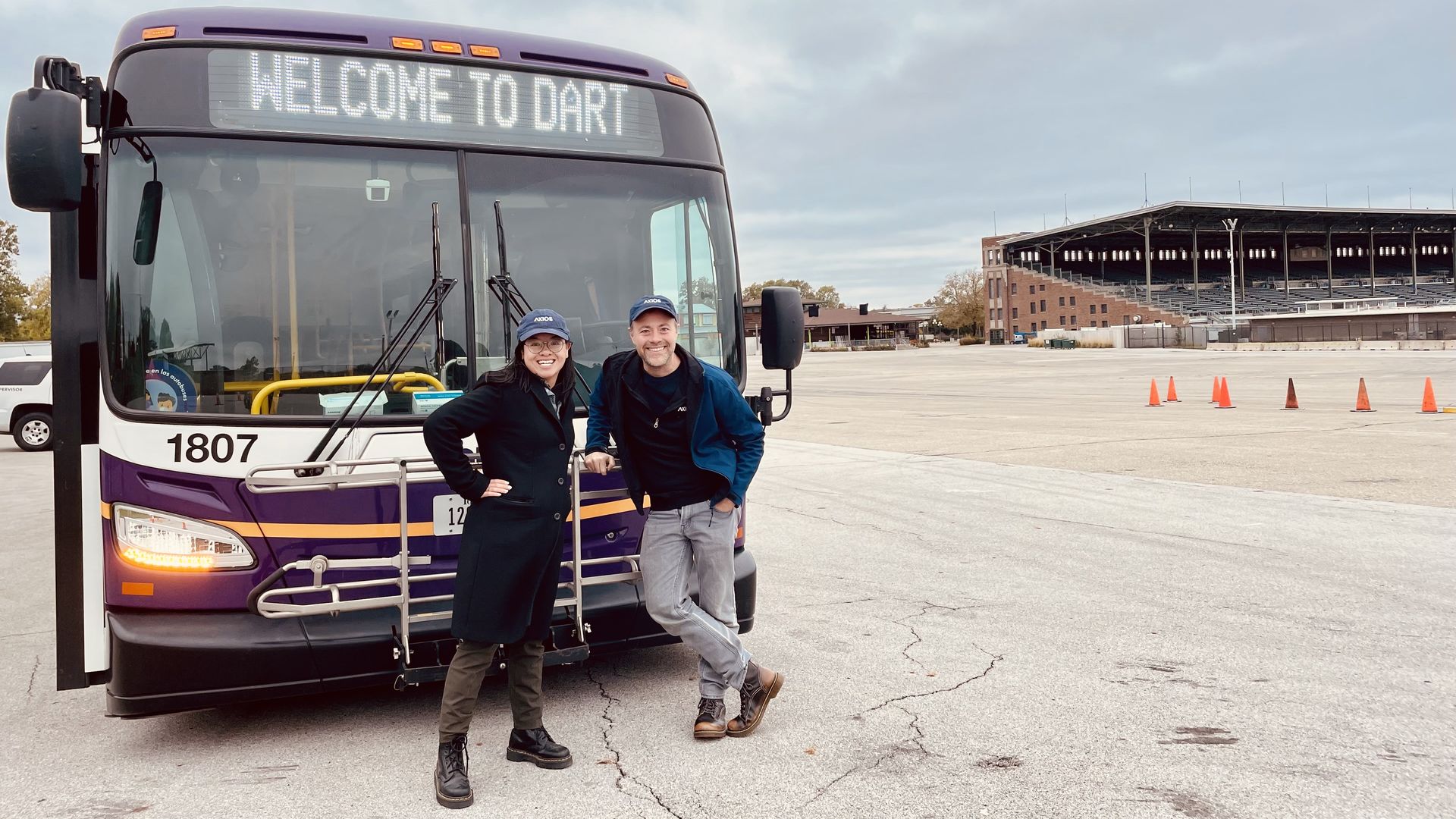 Linh Ta and Jason Clayworth in front of a DART bus.