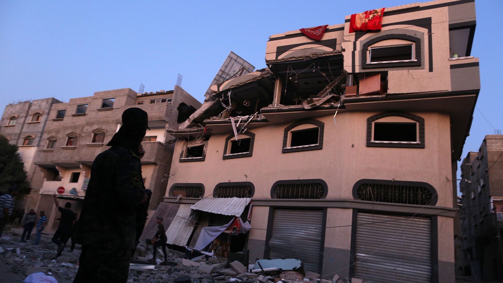Palestinians inspect the damaged house of Islamic Jihad leader Baha Abu Al-Ata afther an Israeli attack in Gaza city, on November 12.