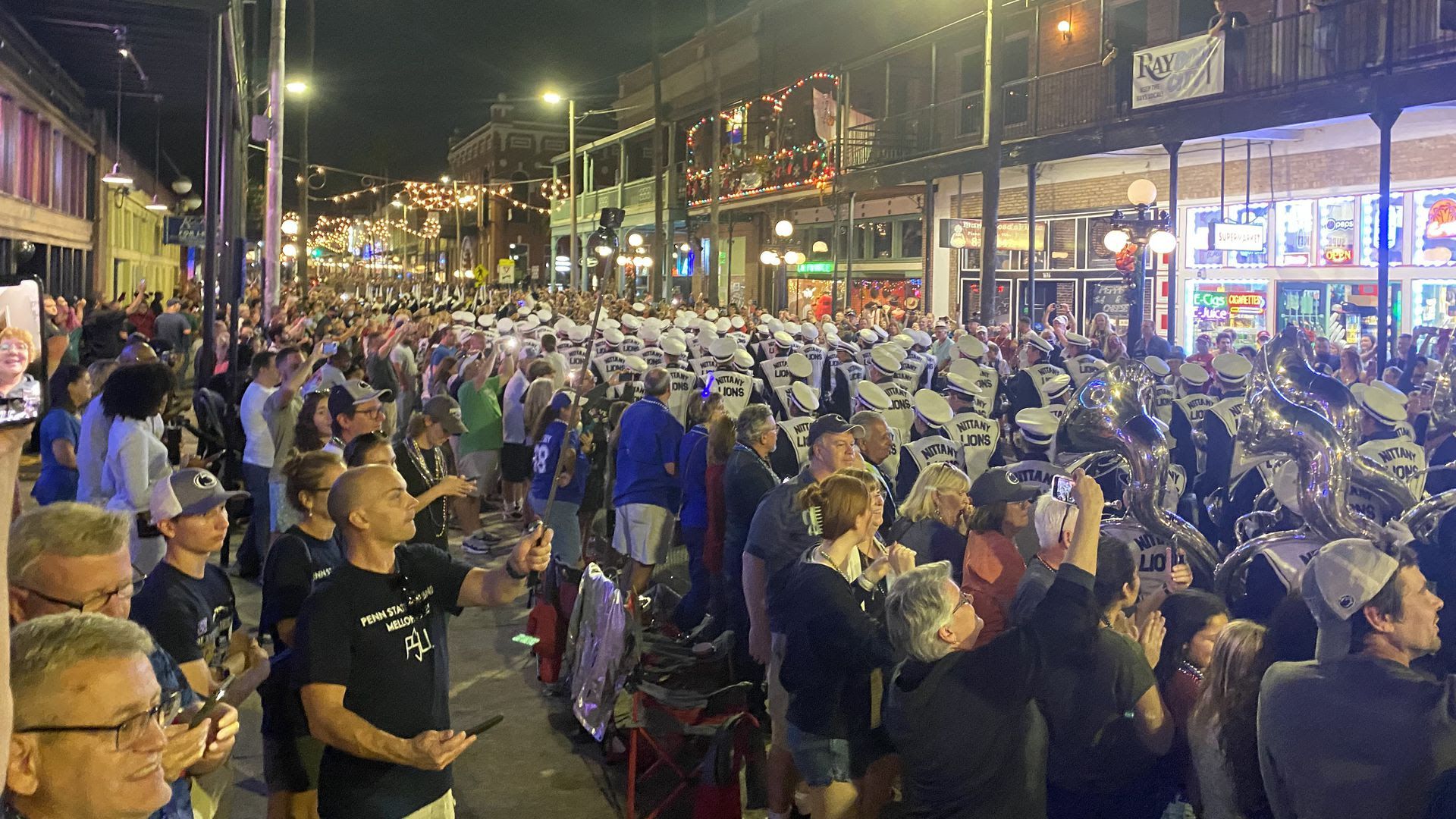 Fans watch the Penn State marching band during the Outback Bowl parade in Ybor City.
