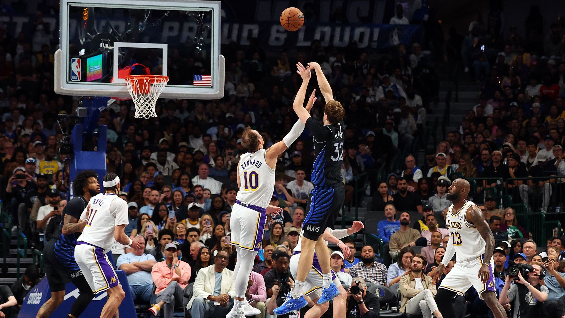 Cooper Flag shoots over a Lakers player with the crowd looking on