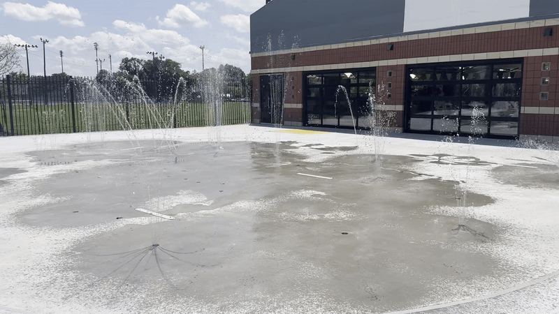 image shows water splashing at a spray park