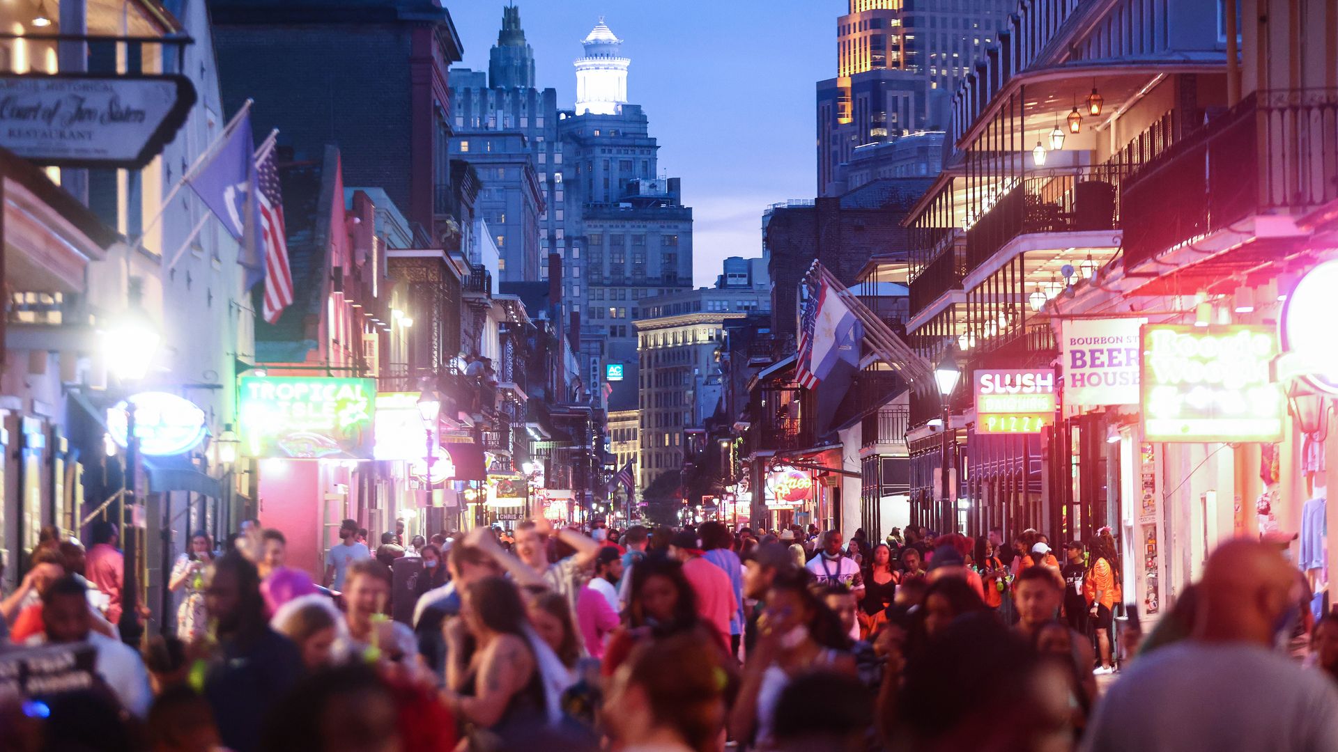 Photo shows a crowded Bourbon Street
