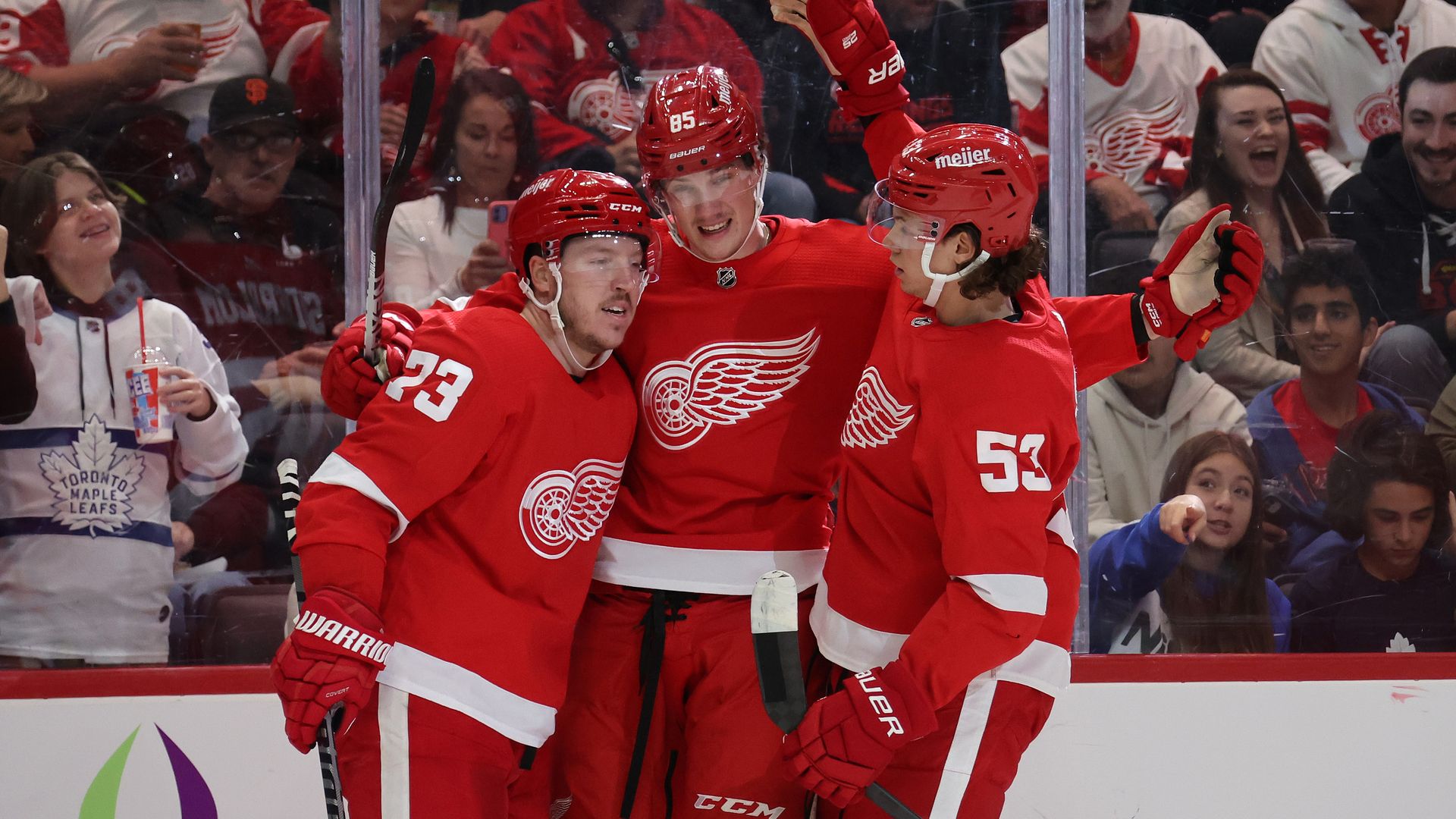Red Wings players celebrate a preseason goal.