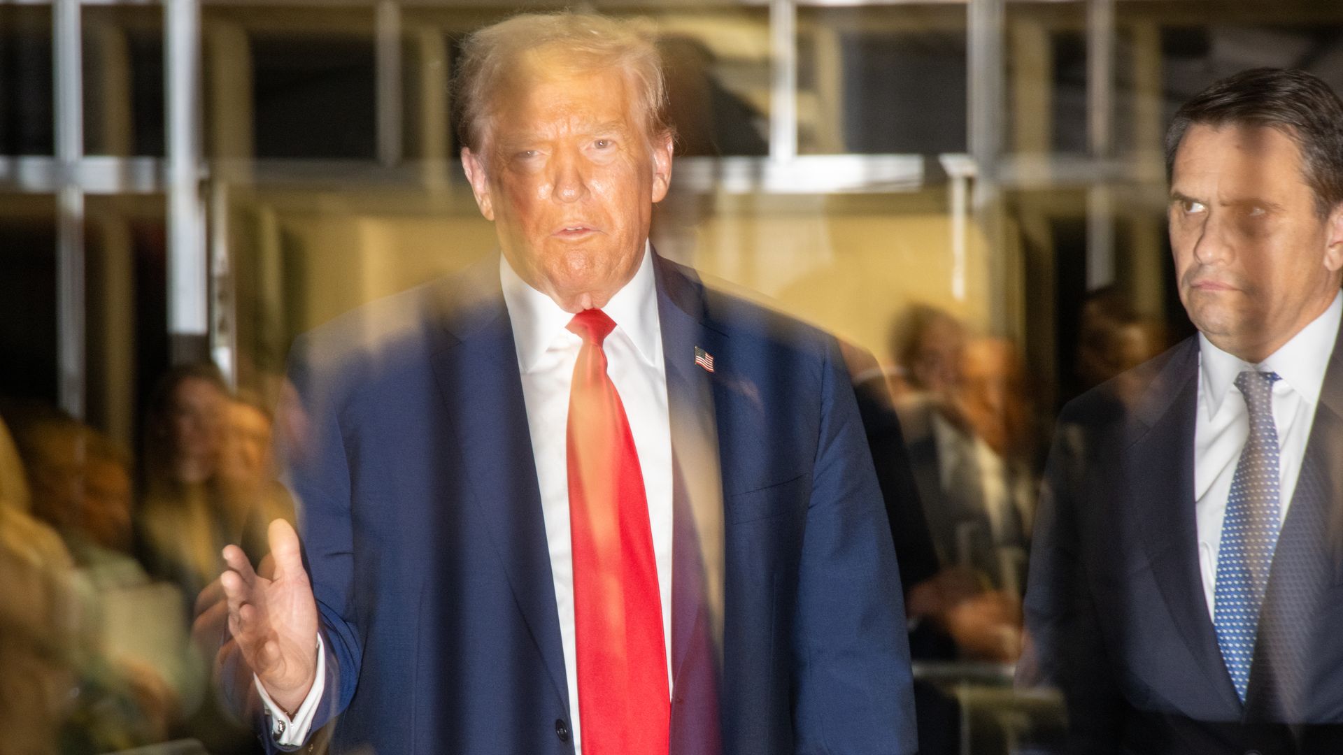 Former U.S. President Donald Trump speaks in the hallway outside of the courtroom at the end of the day's hearing. Photo: John Taggart-Pool/Getty Images. )
