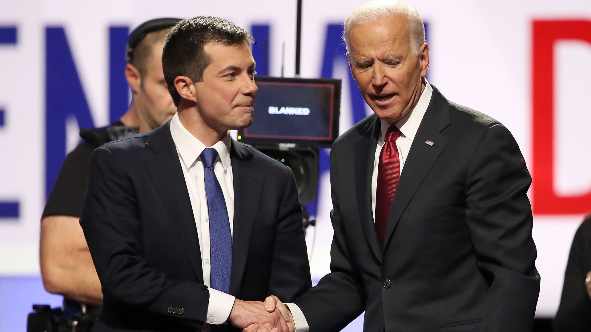 Pete buttigieg shakes hands with Joe biden.