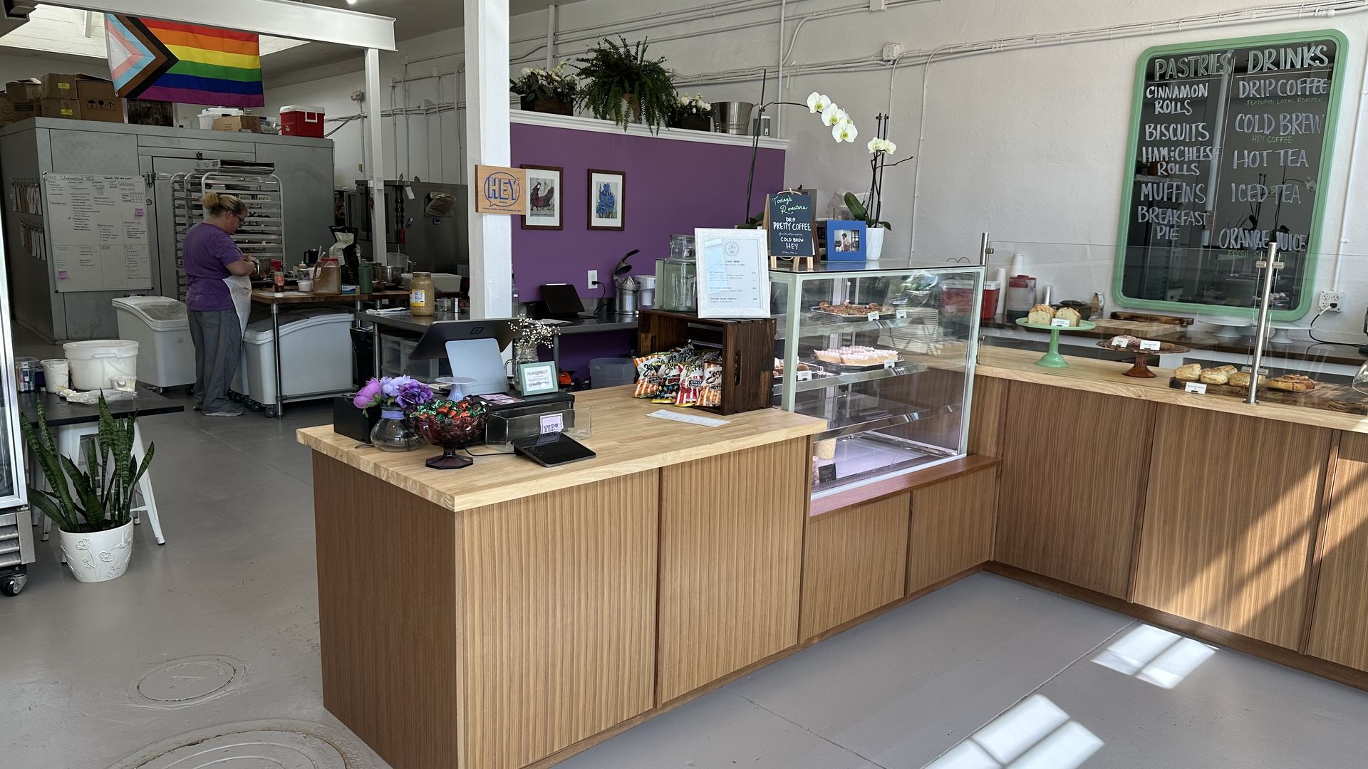 An interior photo of a bakery. The pastry case is in an L-shape.