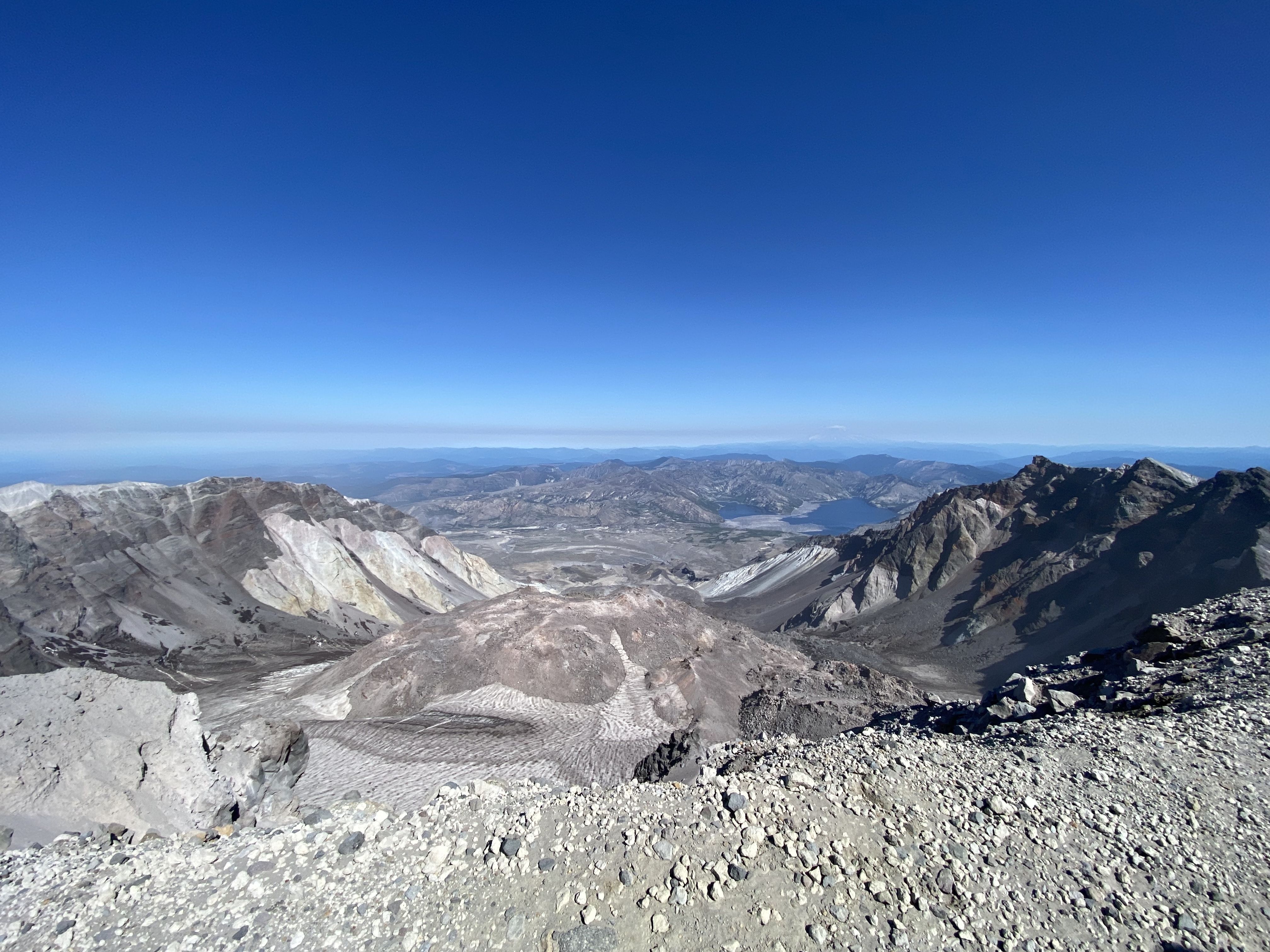 The view from the top of Mount St. Helens with a deep crater.