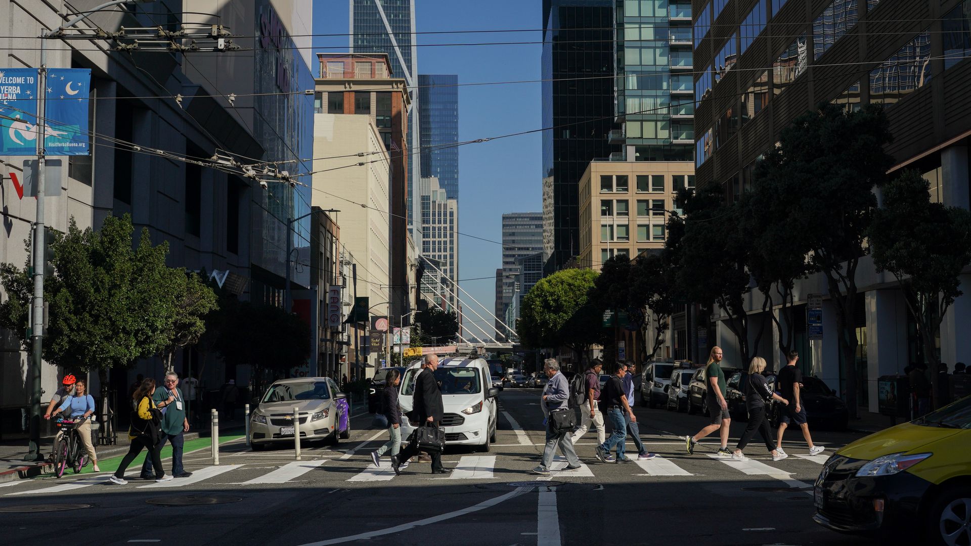 Photo of people crossing a crosswalk in downtown San Francisco in front of waiting cars