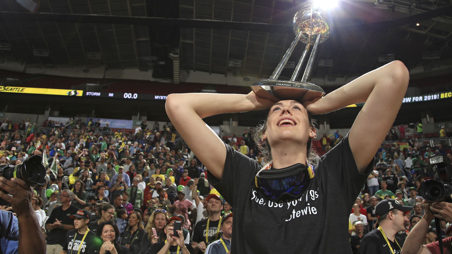 Former Seattle Storm forward Breanna Stewart holding up the 2018 WNBA championship trophy in Climate Pledge Arena in Seattle.
