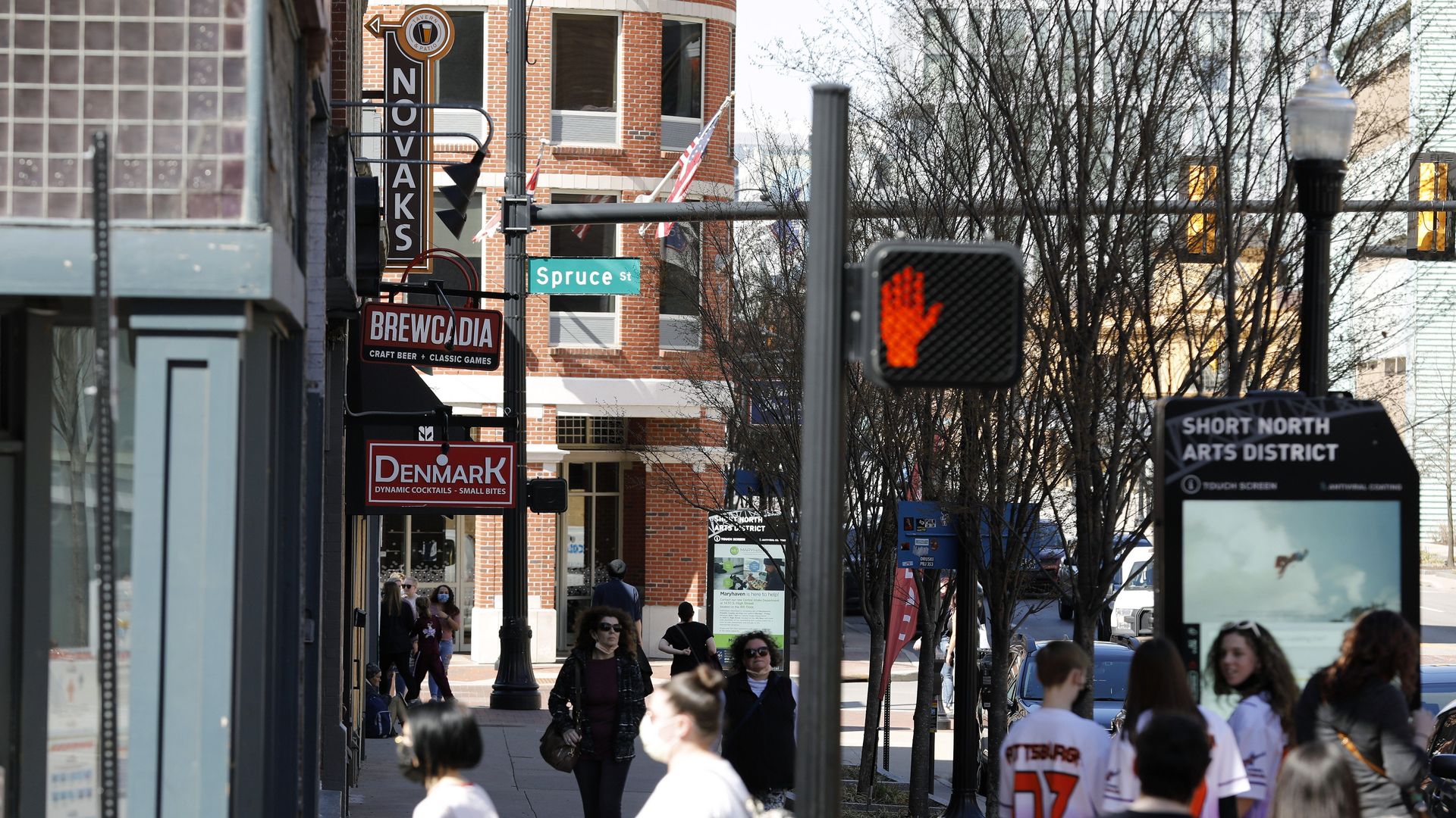 People are seen outside restaurants in Columbus' Arena District.