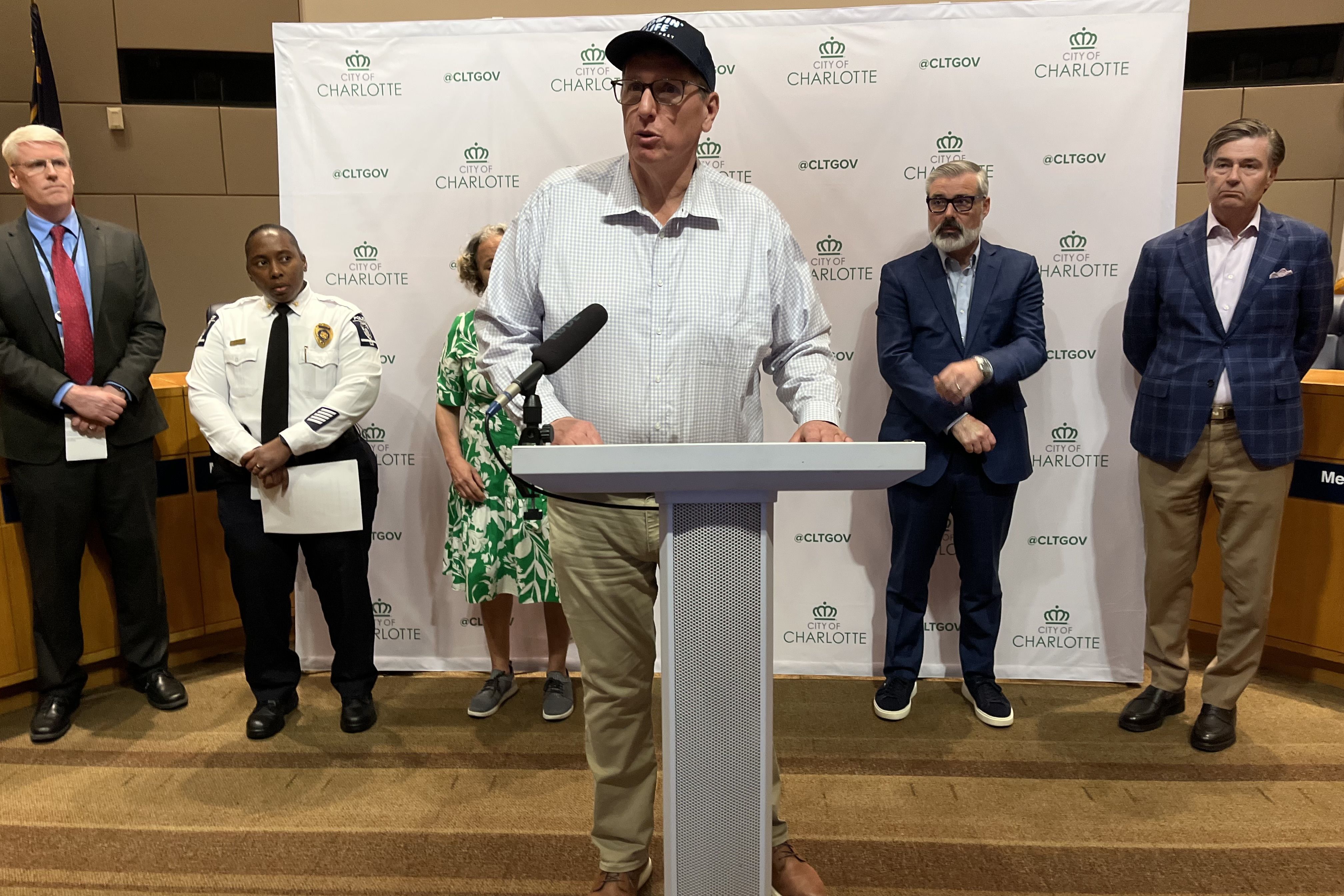 Gregg speaks at a podium during a press conference