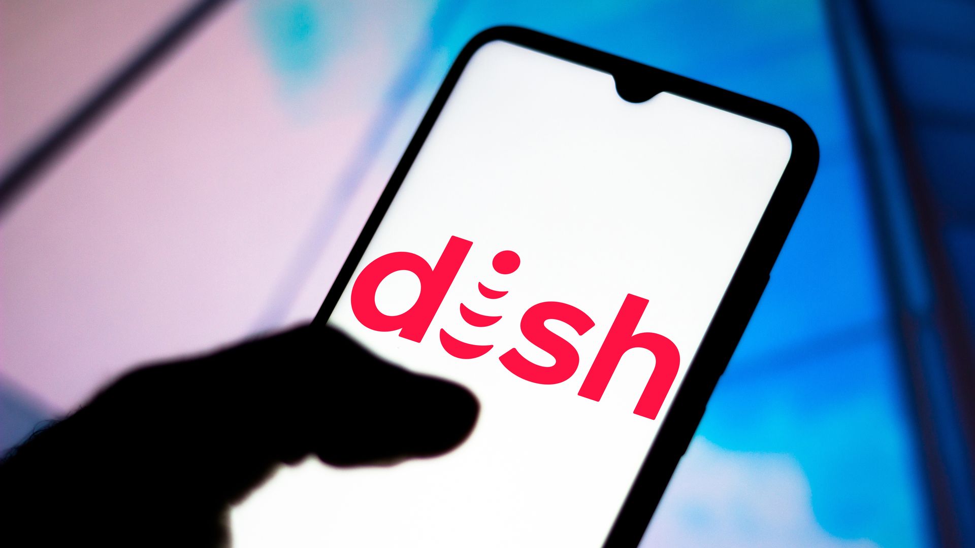 Image of a person holding a phone with the "Dish" logo on the screen.