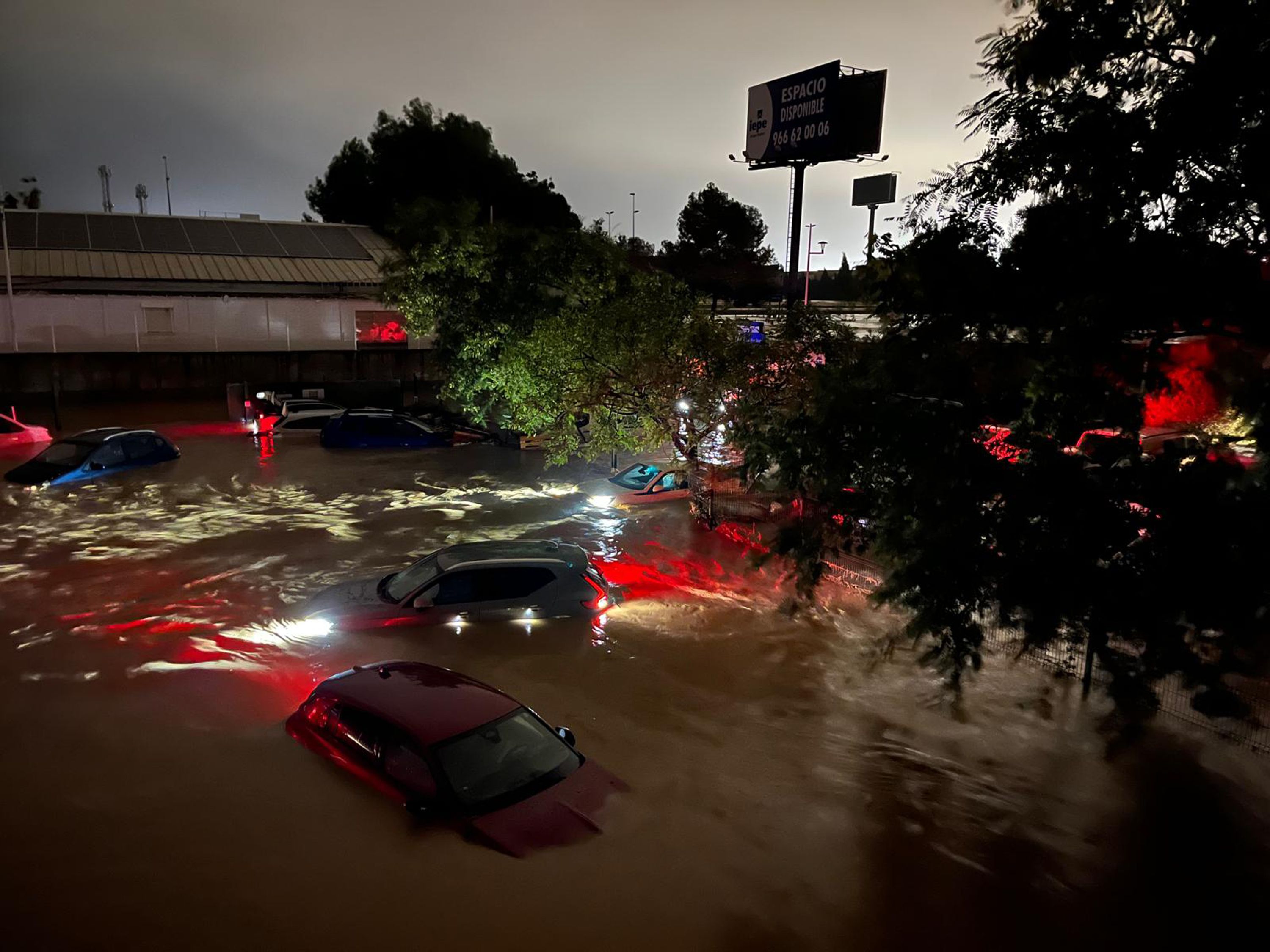 Cars are partly submerged in flood waters on October 29, 2024 on the western outskirts of Valencia, Spain.