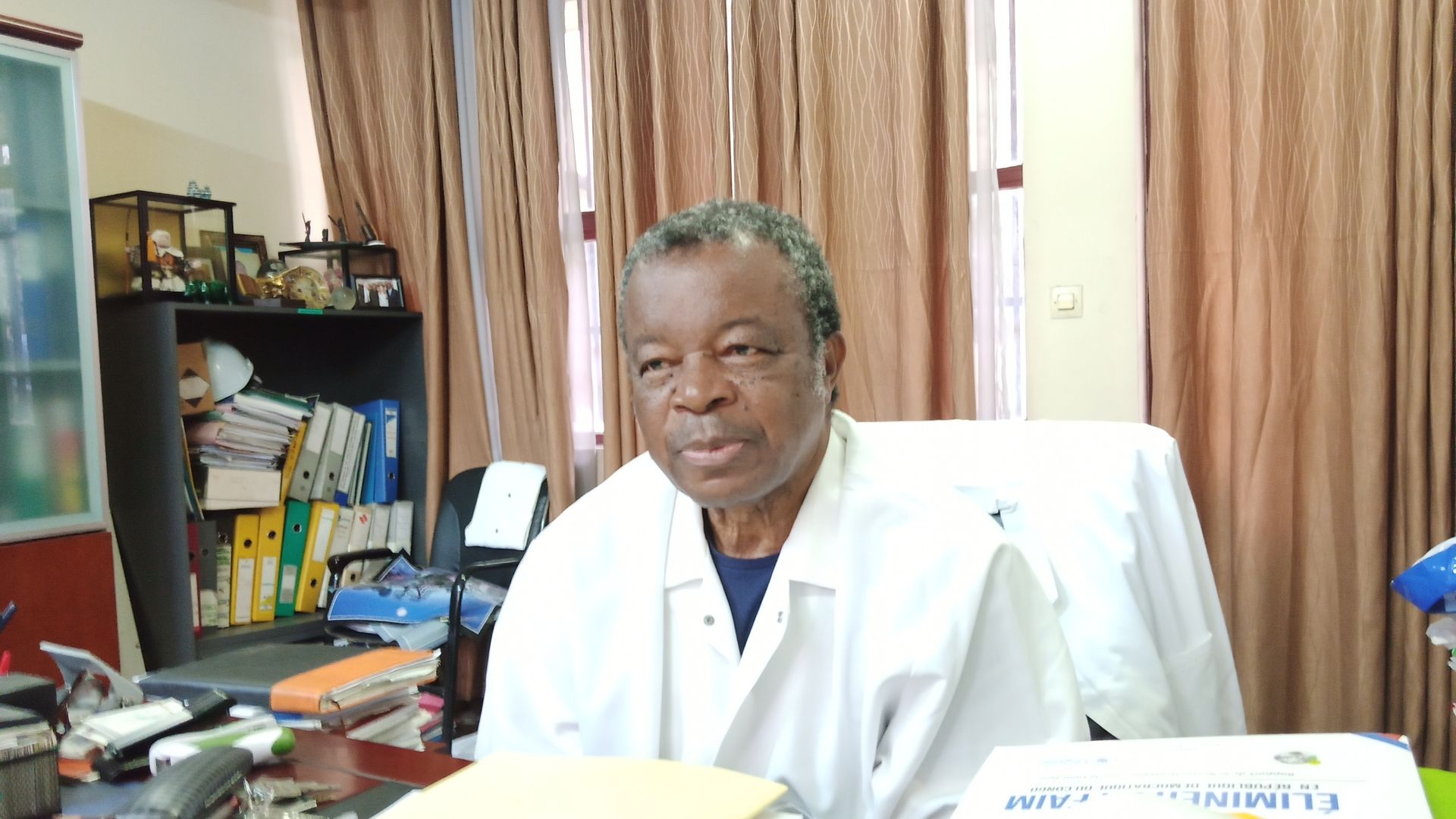 Jean-Jacques Muyembe sitting at his desk during Axios' phone interview