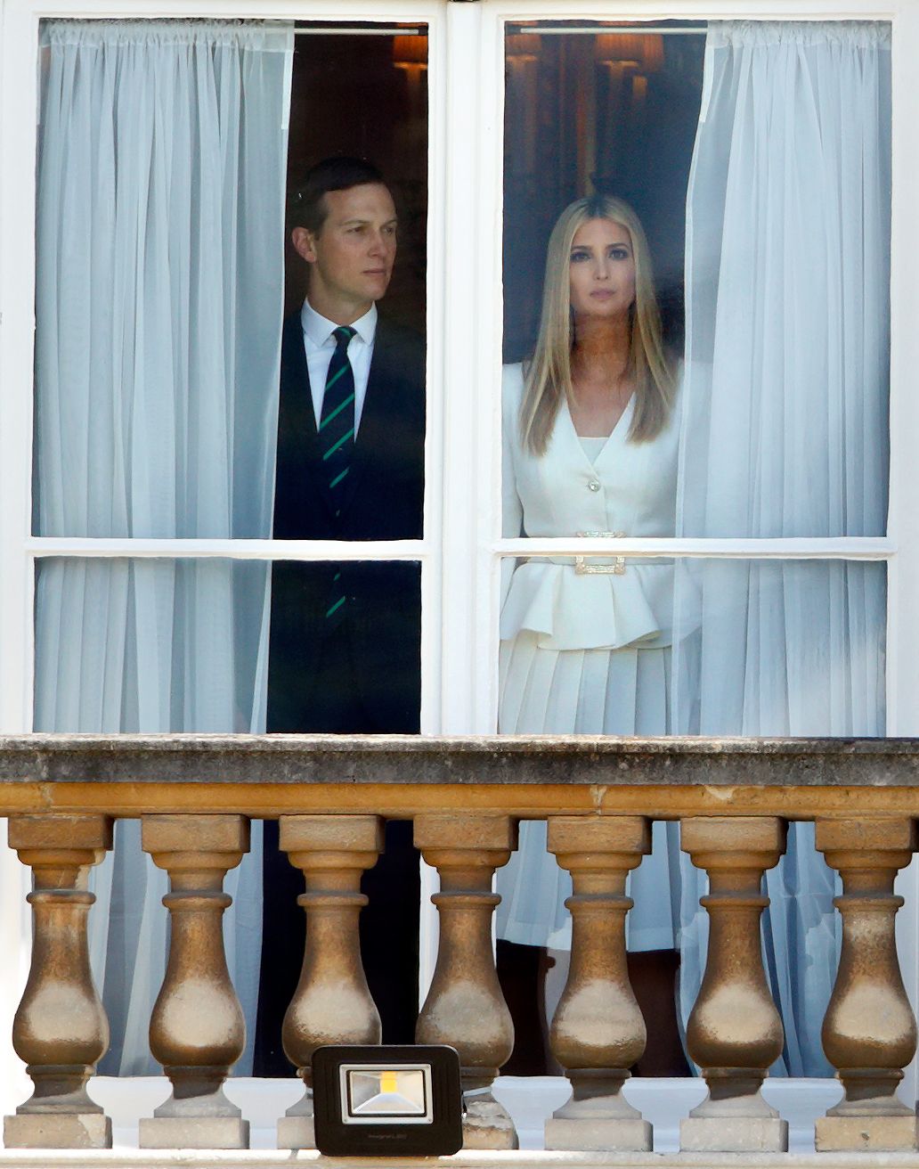 Jared Kushner and Ivanka Trump look out of a window of Buckingham Palace on June 3.