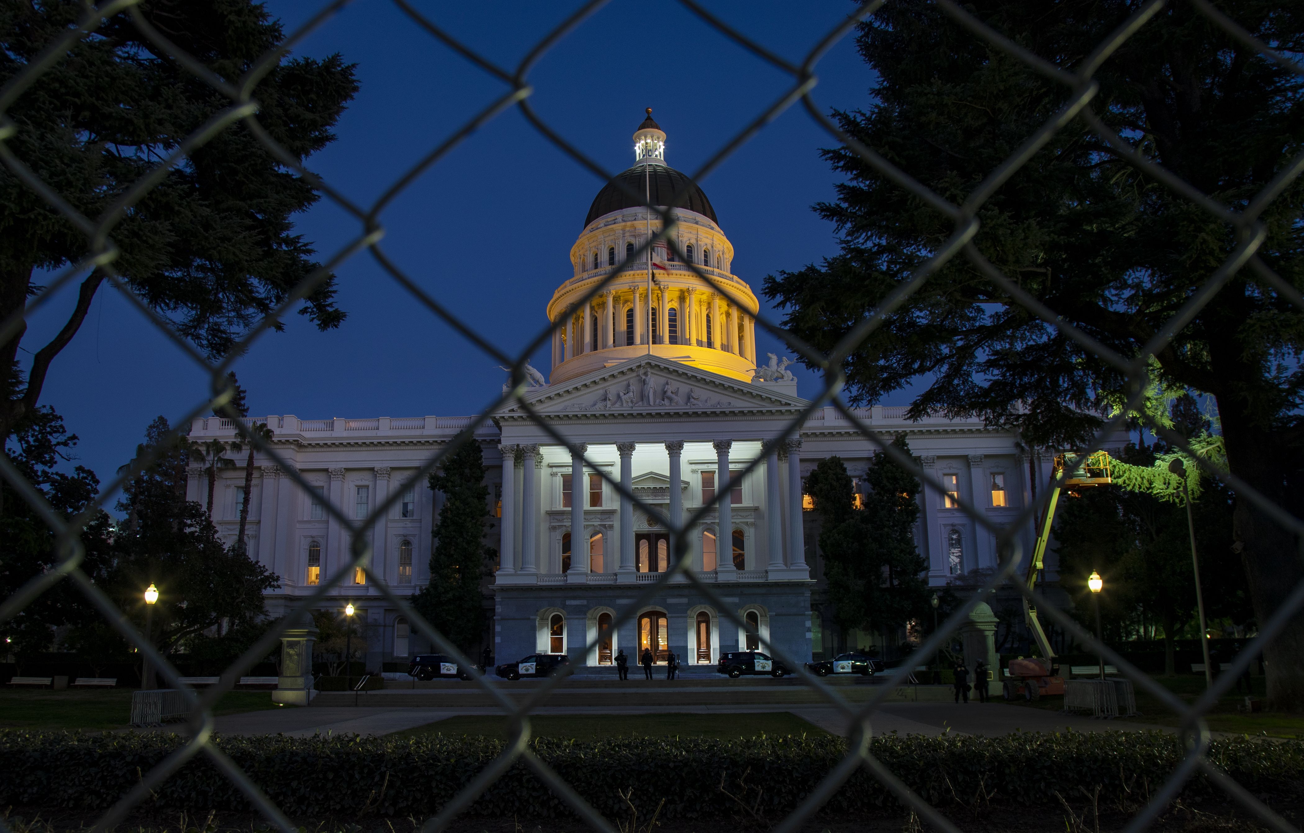 The California State Capitol dome was lit to memorialize lives lost to Covid as CHP officers and the National Guard continue to guard the perimeter on January 19, 2021 in Sacramento