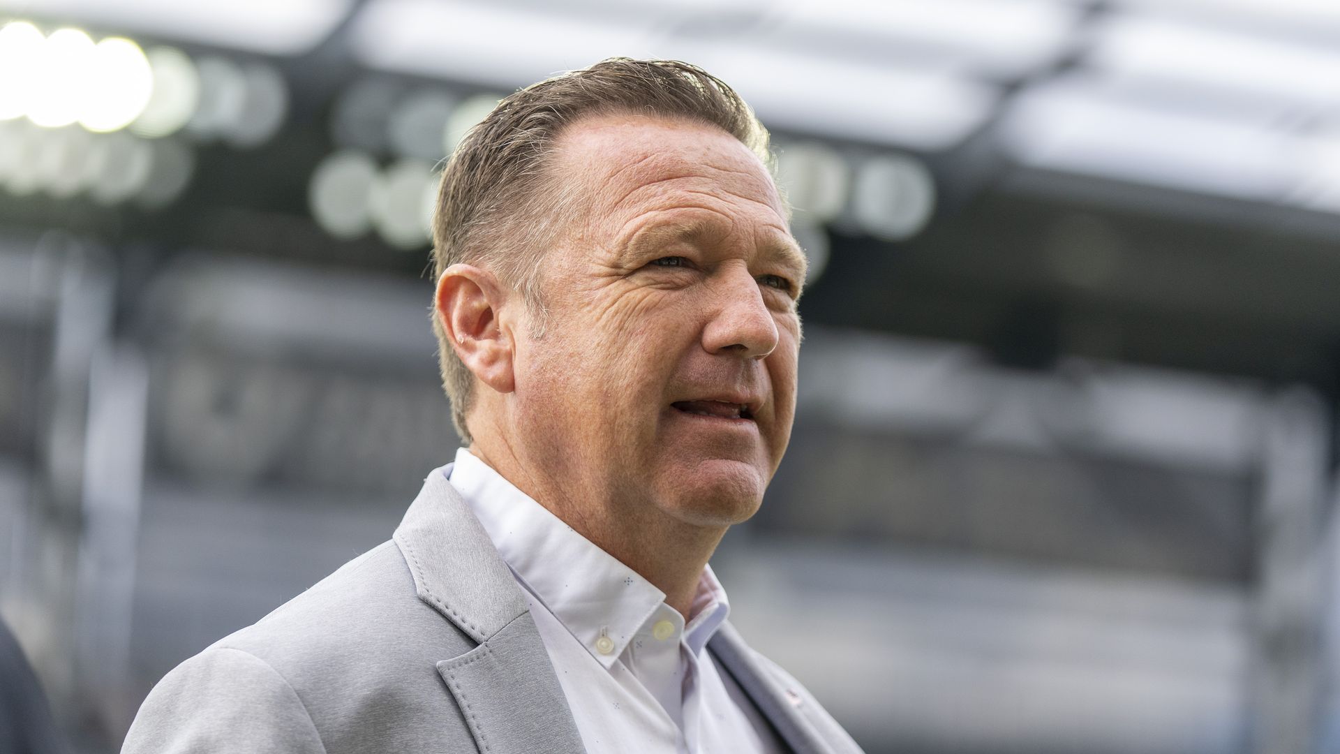 Photo of a man in a gray suit.