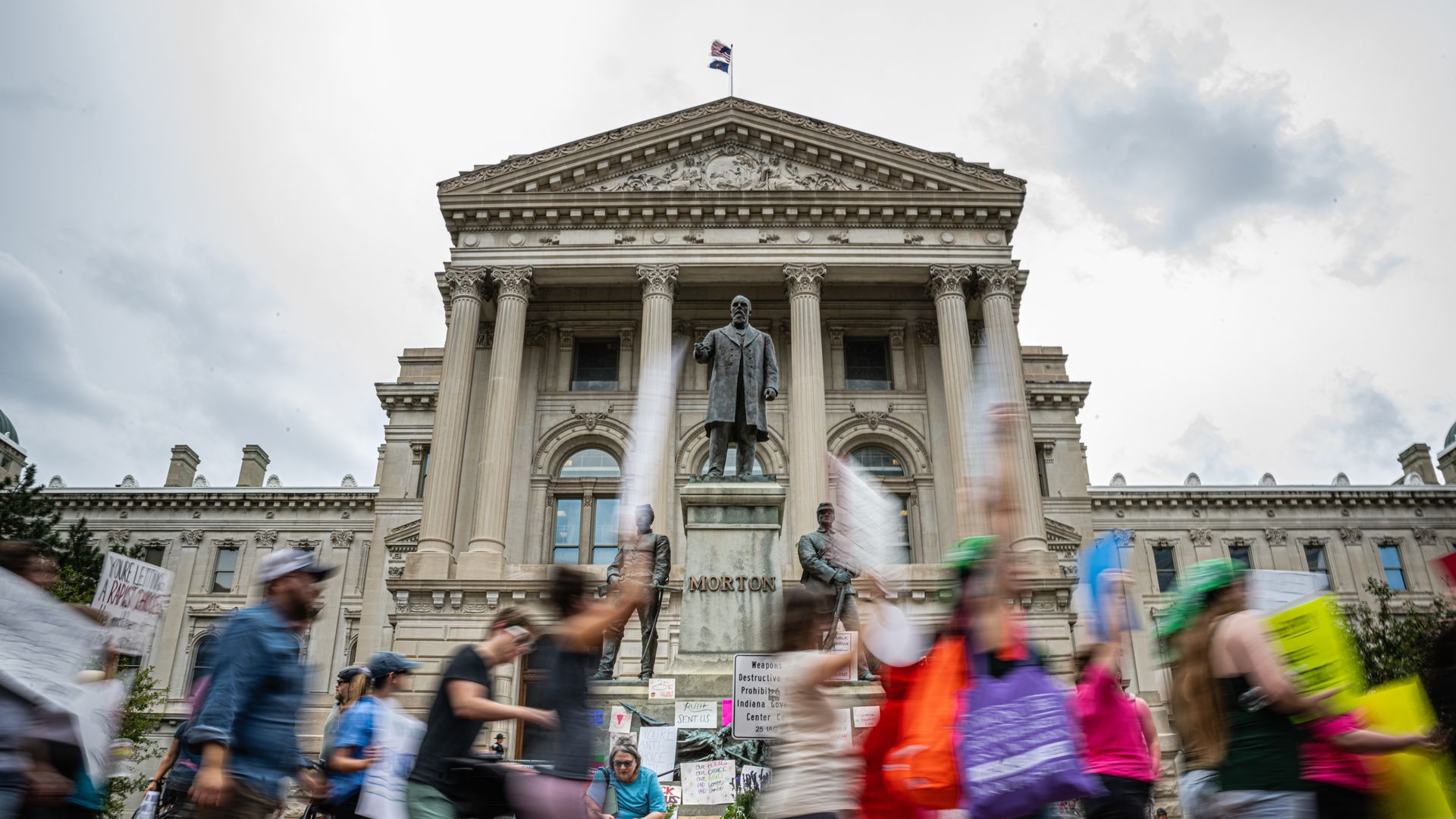 Abortion rights protesters march outside the Indiana State Capitol building.