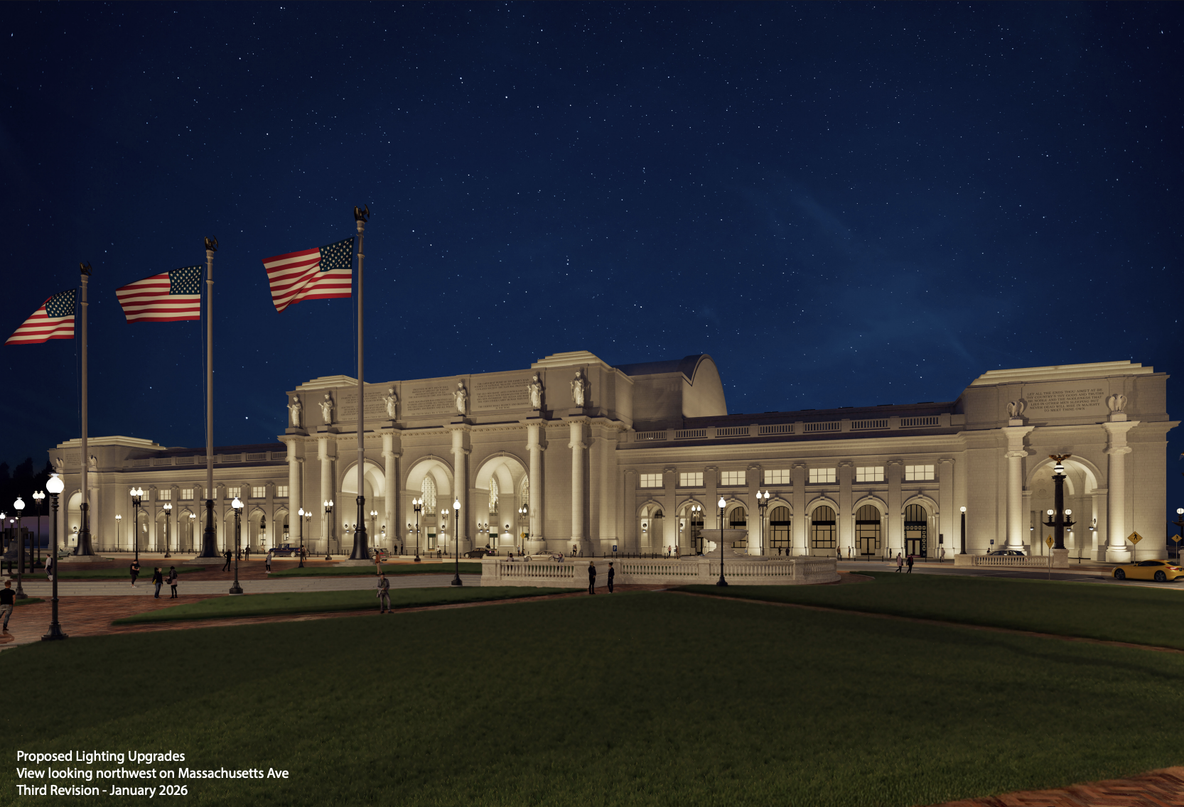 Night view of an illuminated Union Station with archways, American flags on tall poles, and a starry sky above. People walk on paved paths surrounding green lawns.