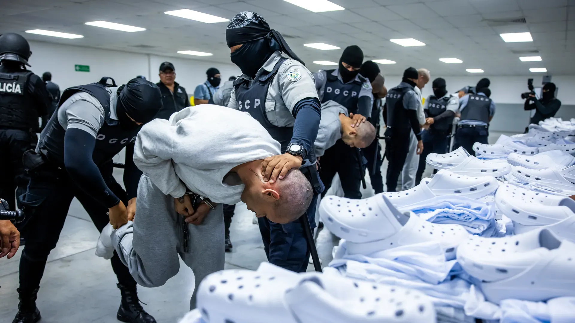 Suspected members of Venezuela's Tren de Aragua and Mara Salvatrucha-13 gang, who were deported to El Salvador by the U.S. in San Salvador, are checked by authorities before being sent to the country's infamous mega-prison at CECOP facility prison. Photo: El Salvador Press Presidency Office/Anadolu 