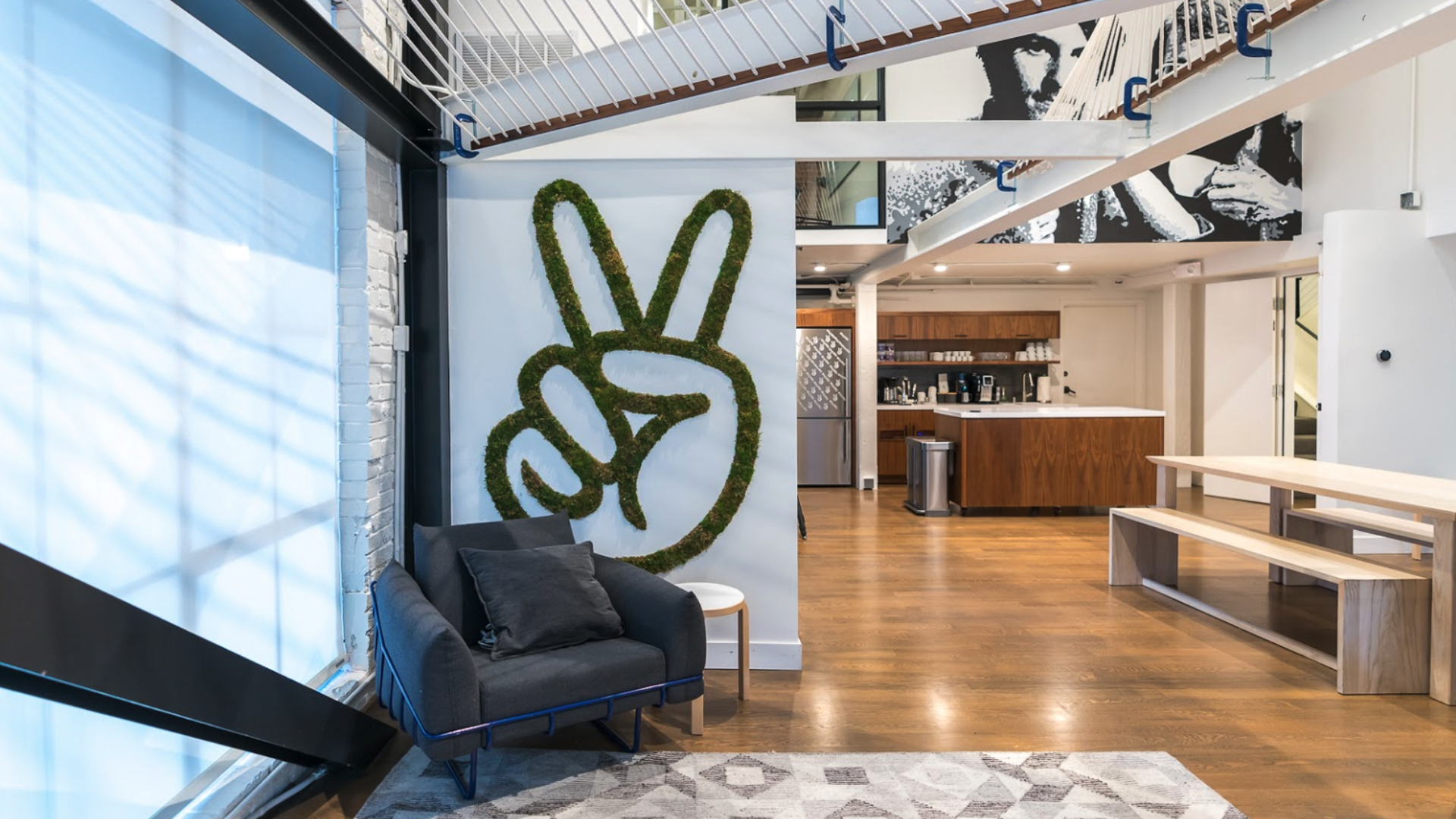 Photo of office of AngelList in San Francisco with logo on a white wall.
