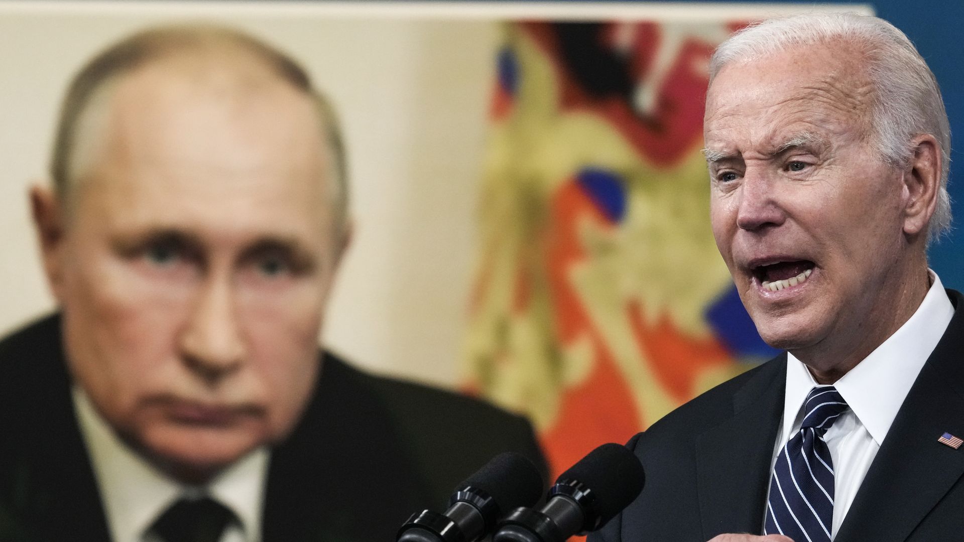 An image of Russian President Vladimir Putin is displayed as U.S. President Joe Biden speaks.