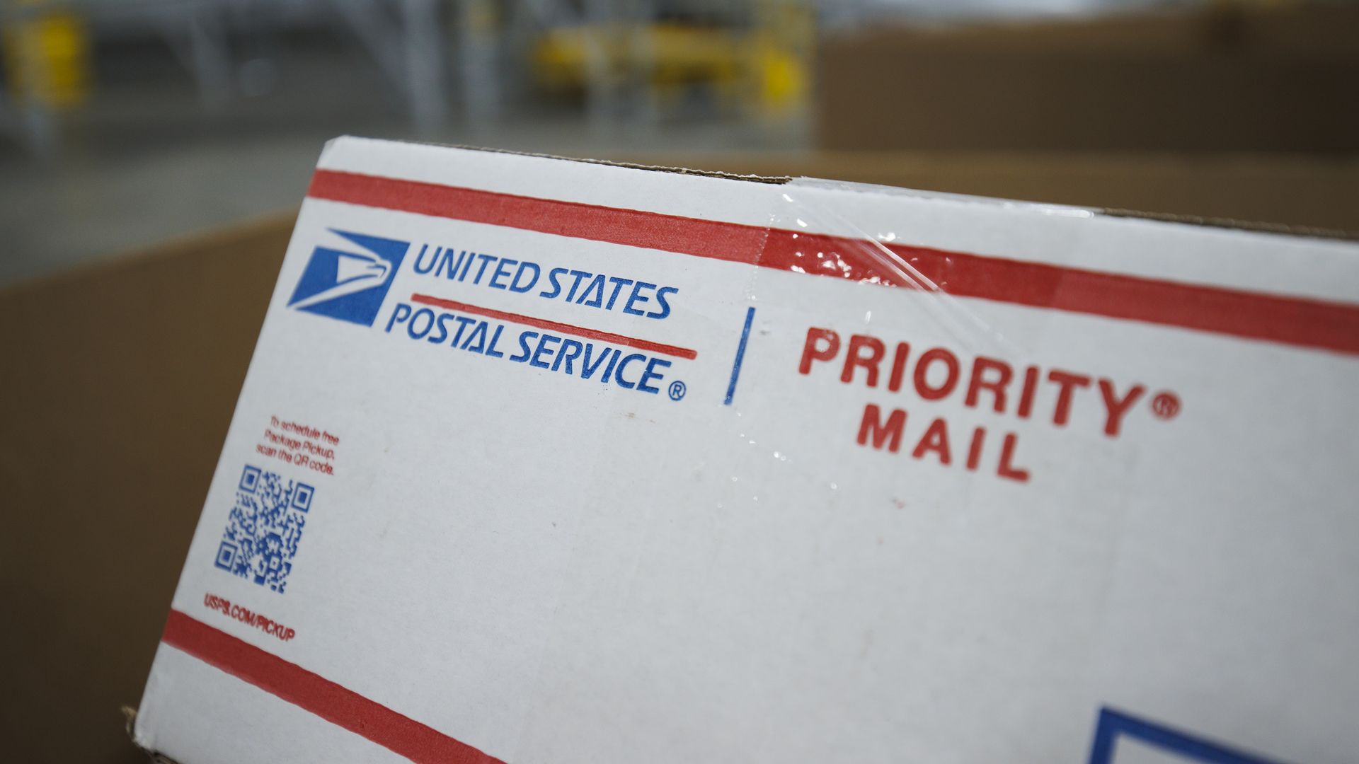 Photo of a white USPS Priority Mail package