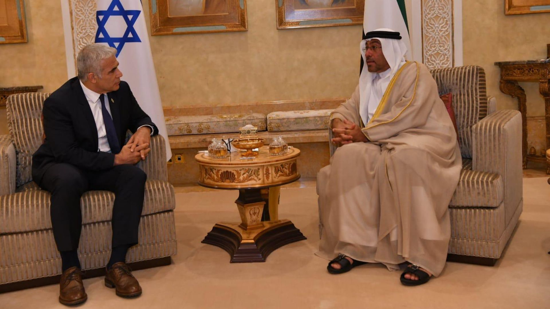 Israeli Foreign Minister Yair Lapid talks with United Arab Emirates Minister of State Ahmed Ali Al Sayegh.