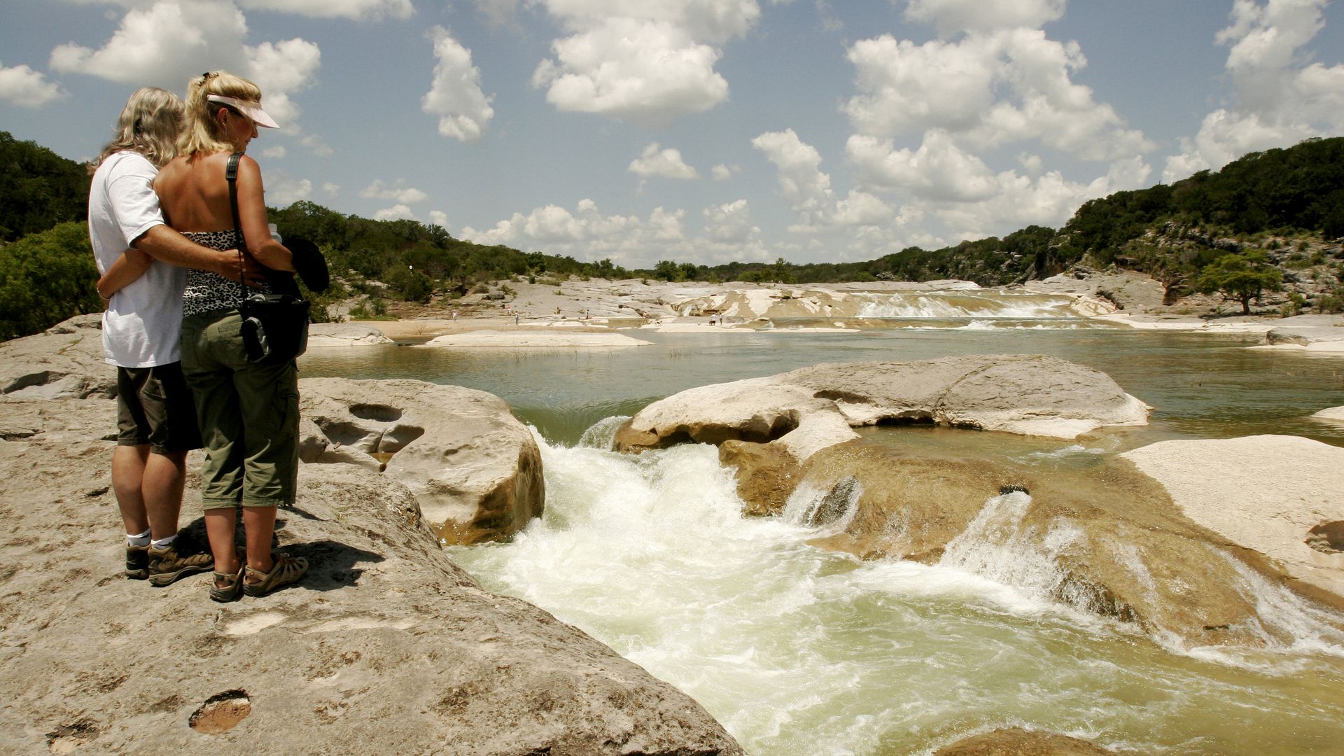 A couple observes the scenery at Pedernales Falls State Park. 