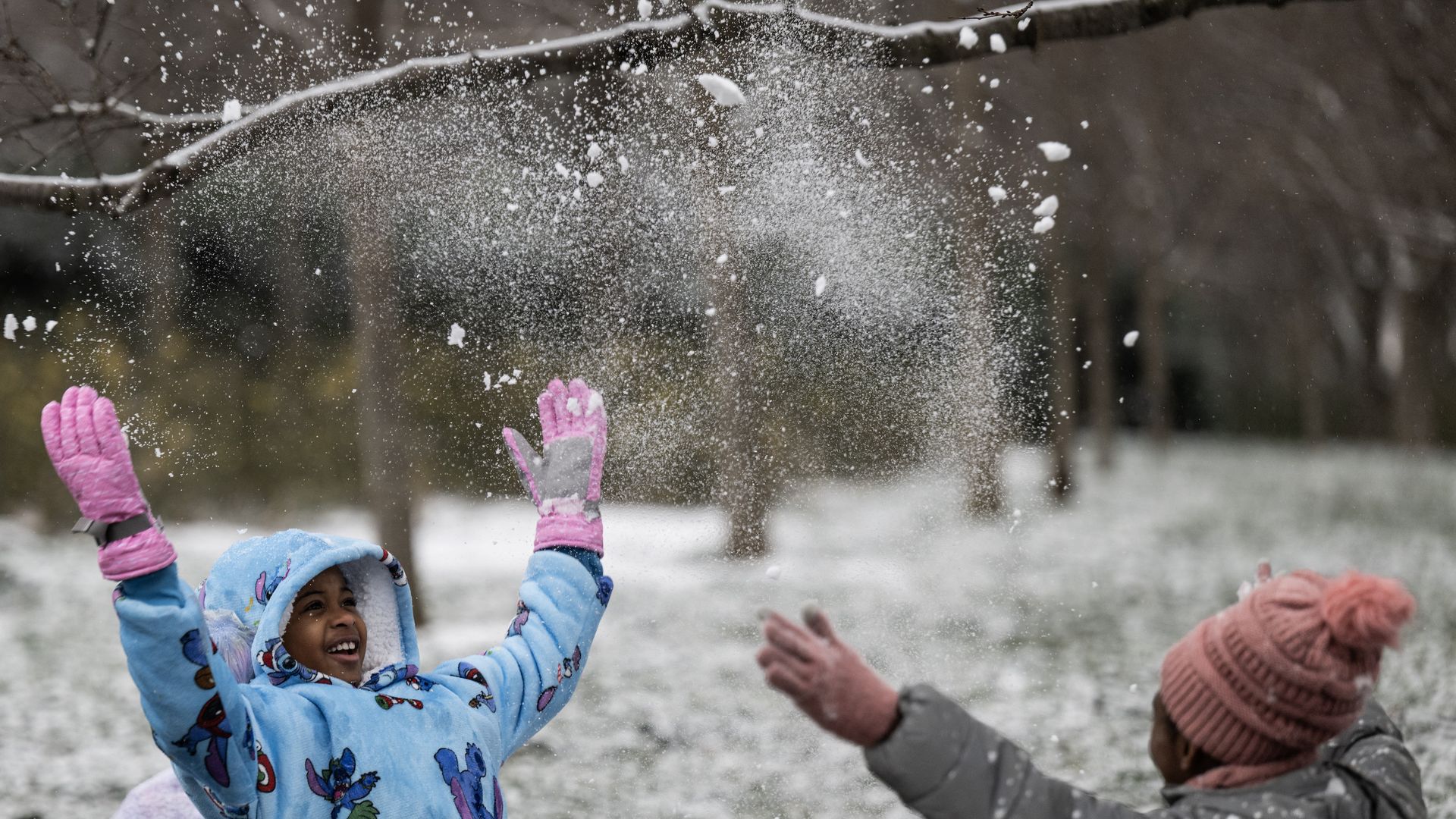 Kids play in the snow near the Martin Luther King Jr. Memorial during a winter storm on Jan. 15 2024.