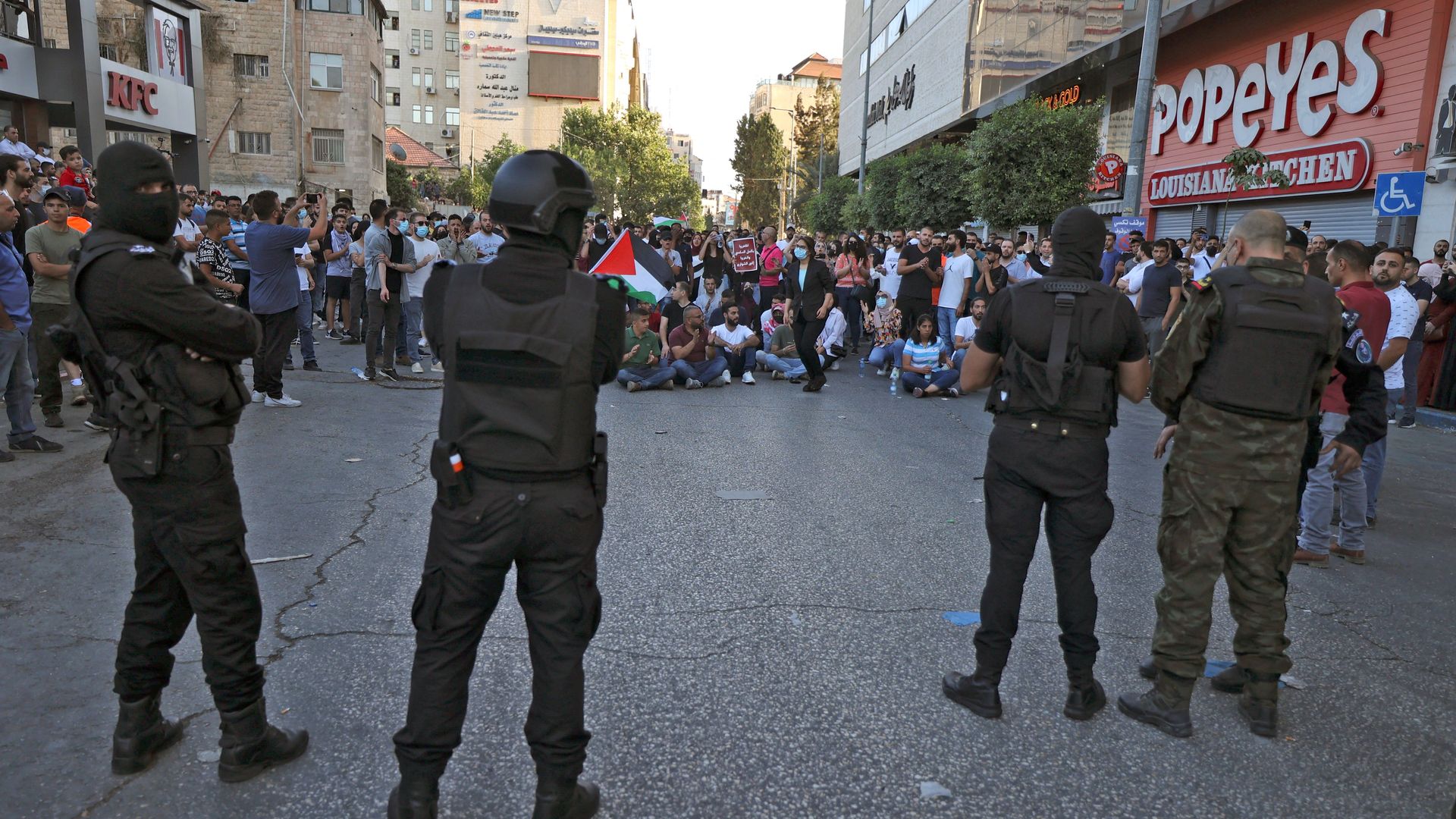 Palestinian security forces deploy as demonstrators rally in Ramallah city in the occupied West Bank on July 3, 2021