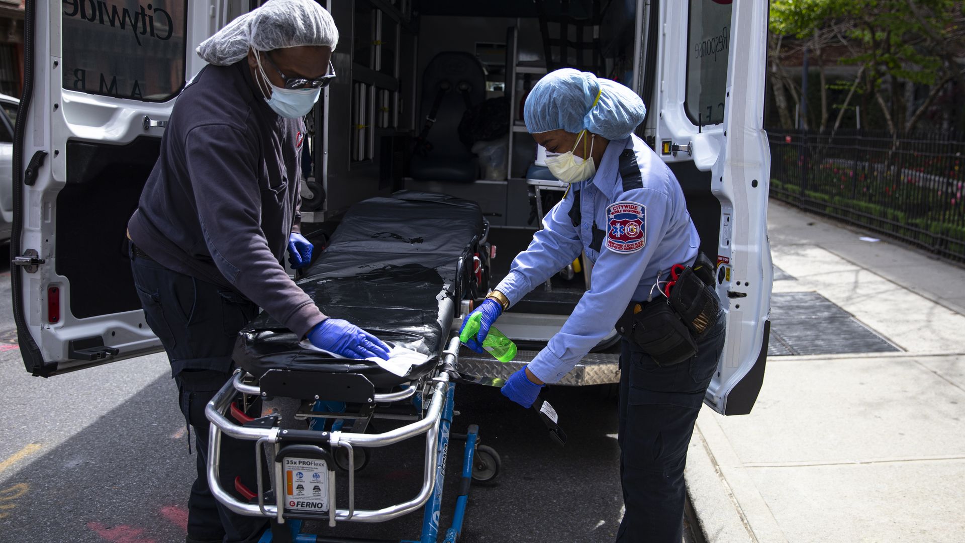 Health care workers after dropping off a patient at a nursing home. Photo: Robert Nickelsberg/Getty Images