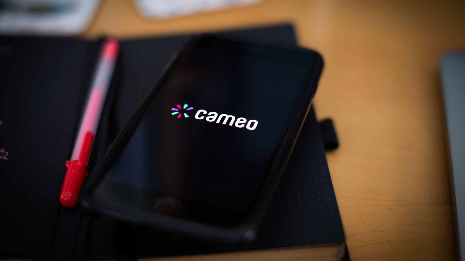 Photo of a phone with the word Cameo on the screen. 