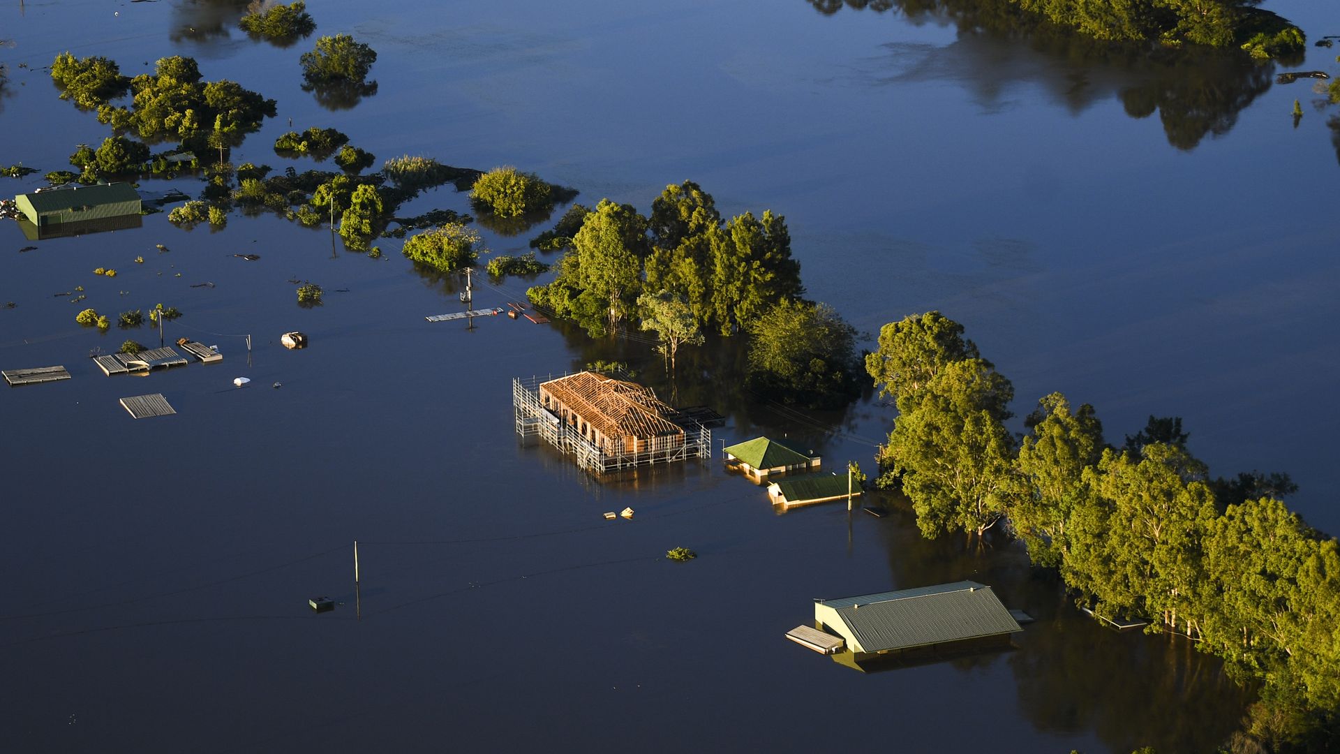 Partly submerged houses are seen from a helicopter in flood affected areas in the Windsor and Pitt Town areas along the Hawkesbury River on March 24, 2021 in Sydney