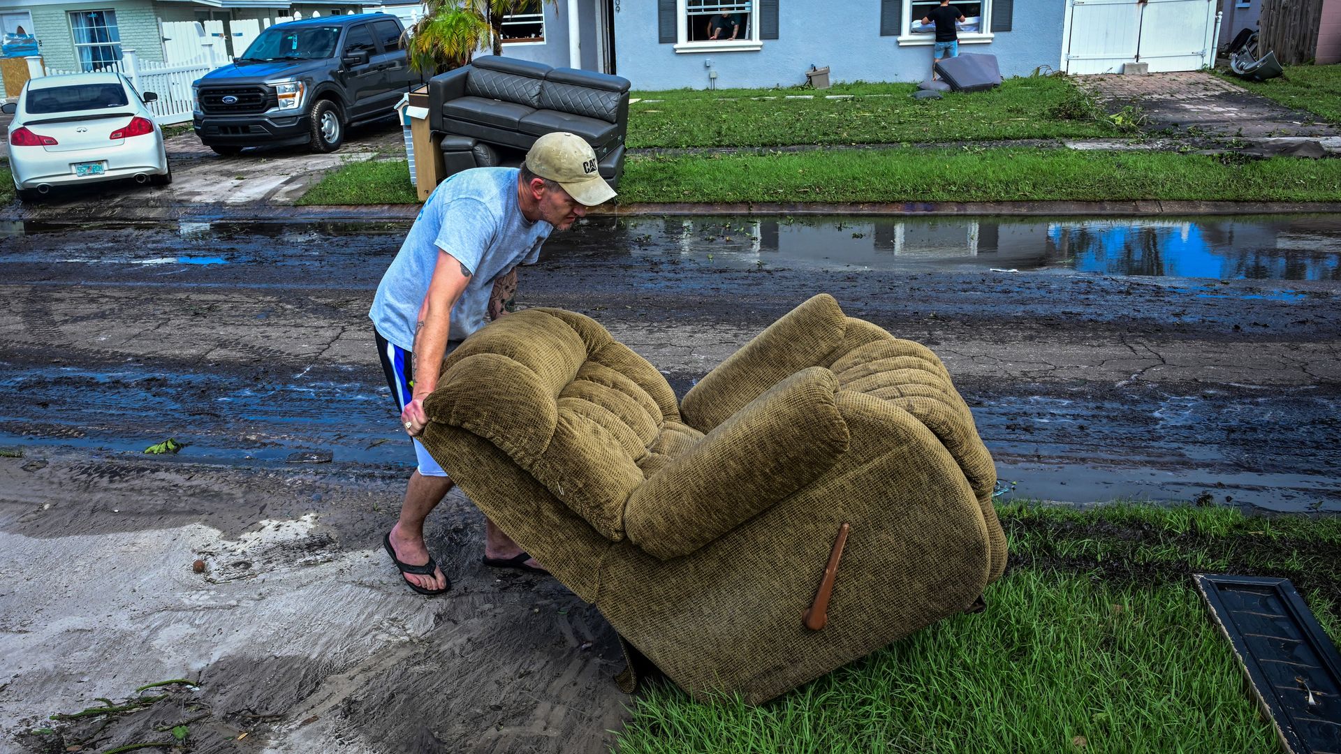 A man moves a chair in Tampa, Florida, as people remove debris and clean their homes after  Hurricane Milton on Oct. 11.