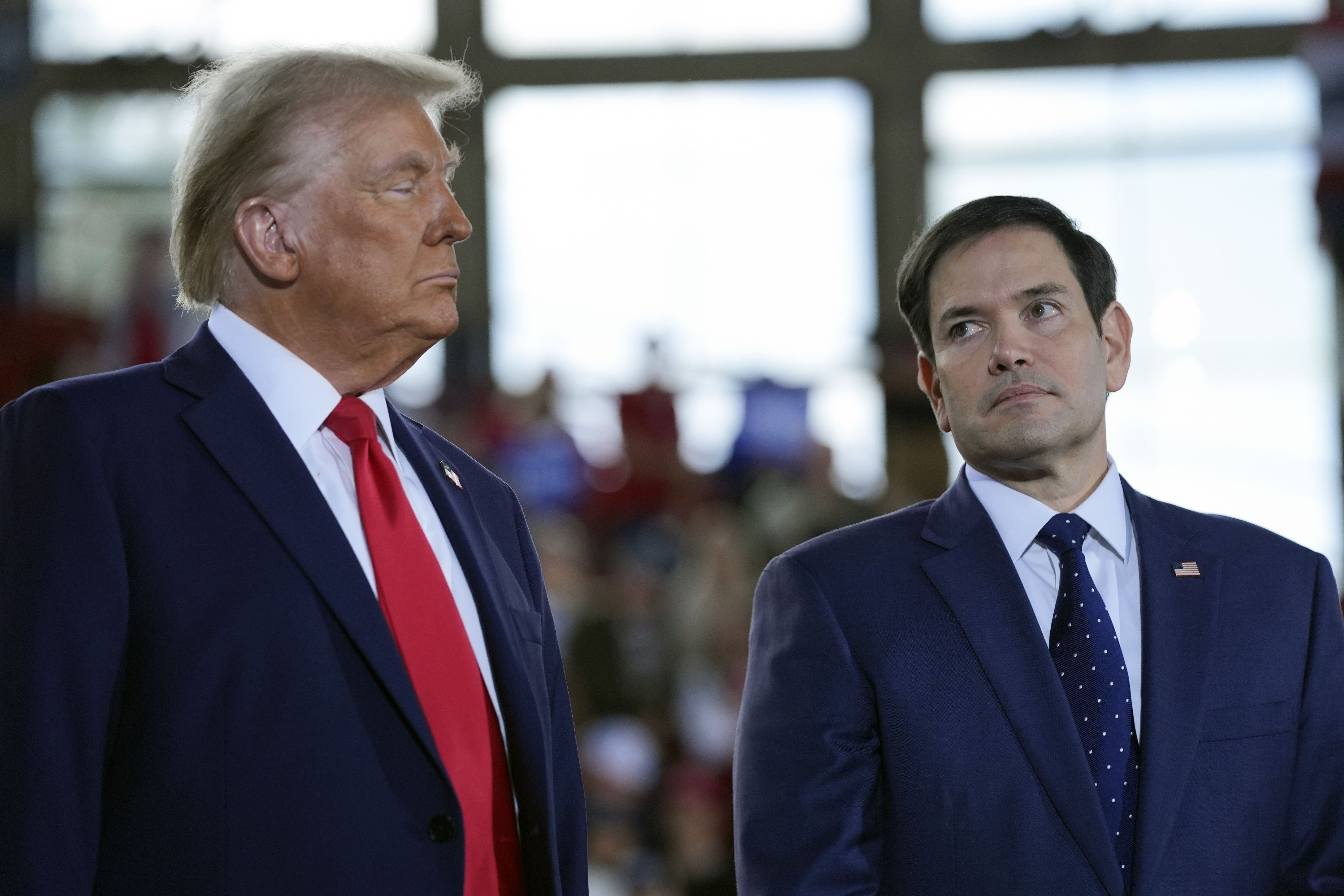 Former President Trump speaks with Sen. Marco Rubio (R-Fla.) during a November campaign rally in Raleigh, N.C.