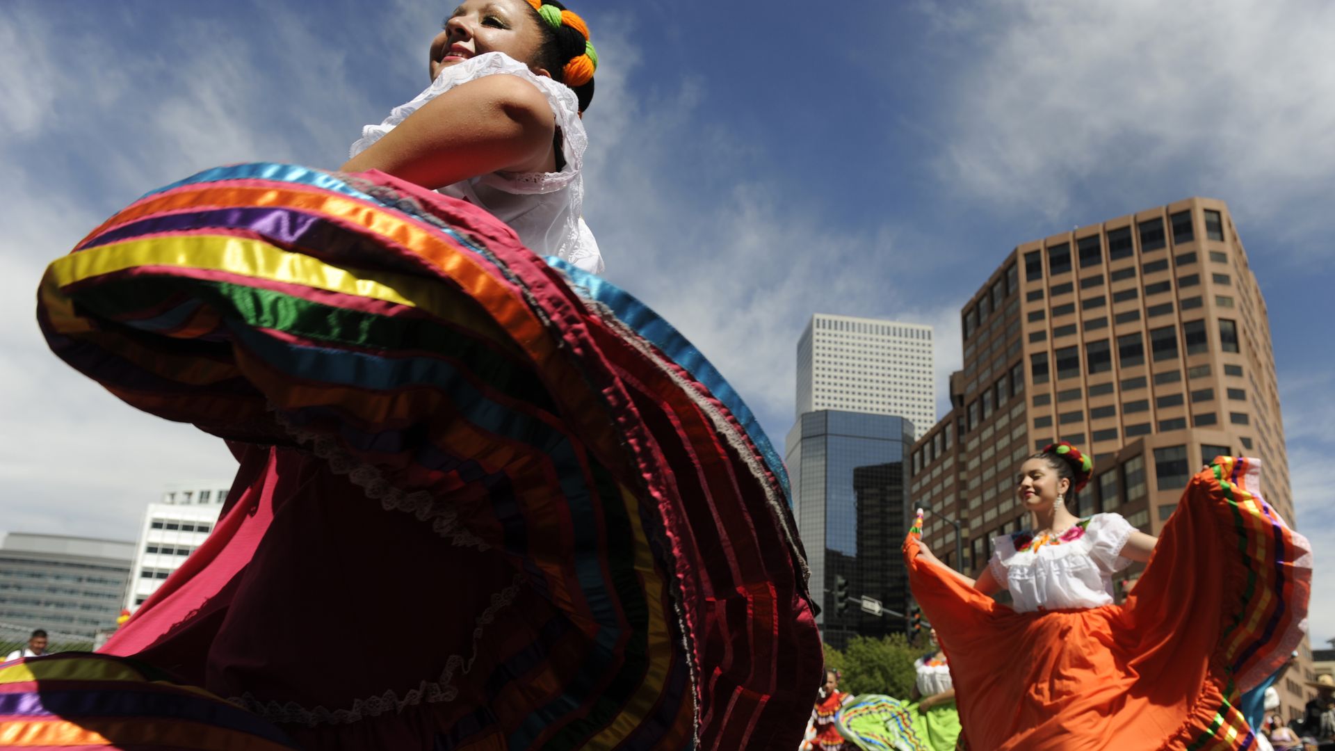 Two Mexican dancers twirl their colorful dresses in Civic Center Park