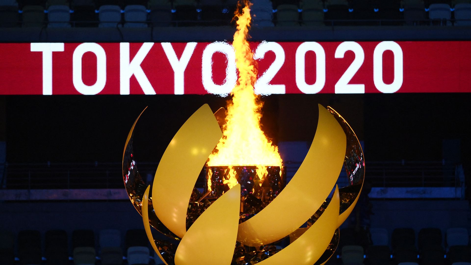 Picture of the cauldron lit with the words "Tokyo 2020 in the background"