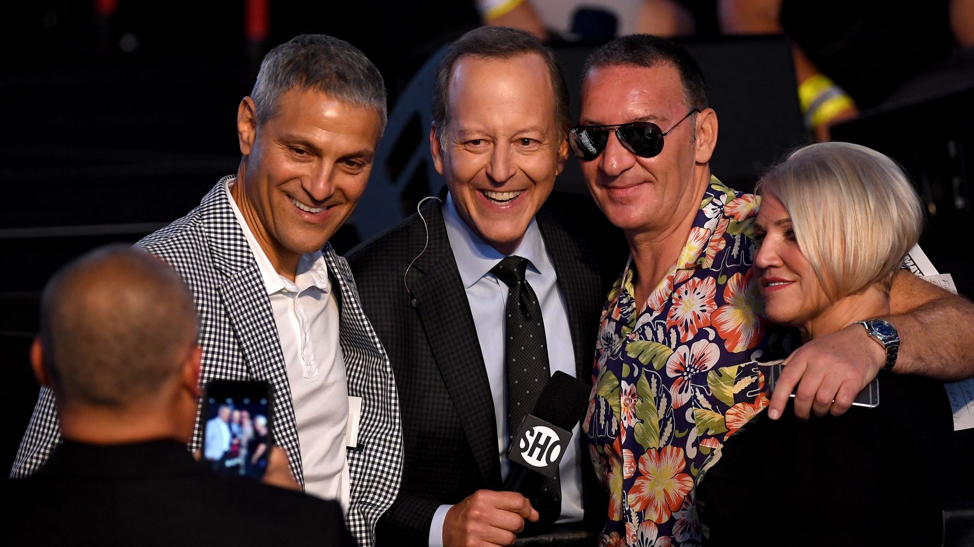 In this image, Ari Emanuel poses with two men and a blonde woman for a picture.