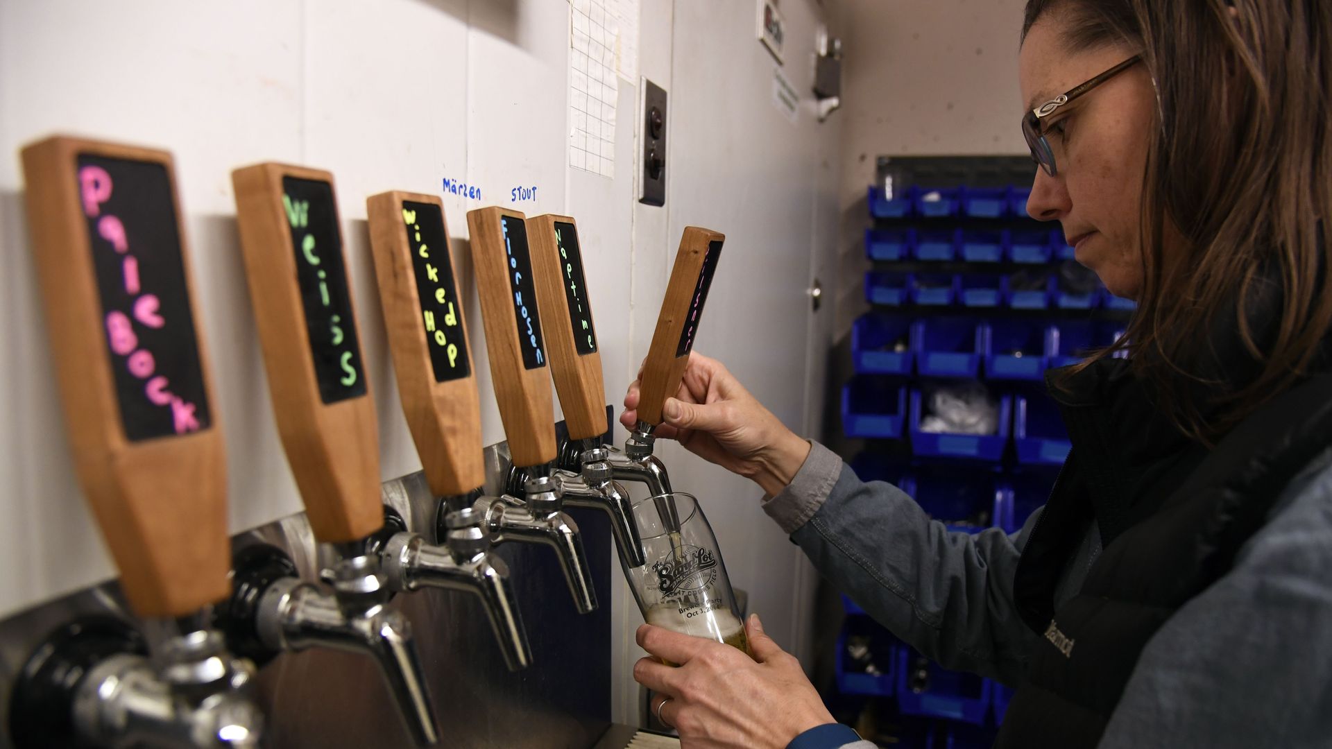 Melissa Arp pours herself a Pilsner in the Sandlot Brewery's tasting room at Coors Field in 2017.