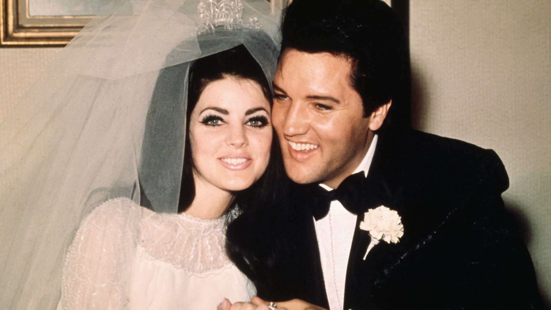 Elvis Presley sits cheek to cheek wit his bride Priscilla  following their wedding May 1, 1967.