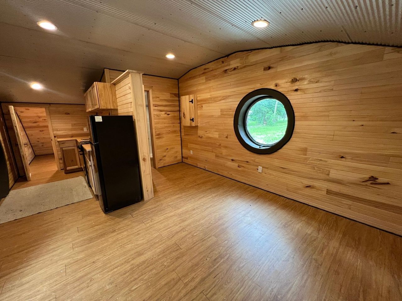 A living room with a circular window.