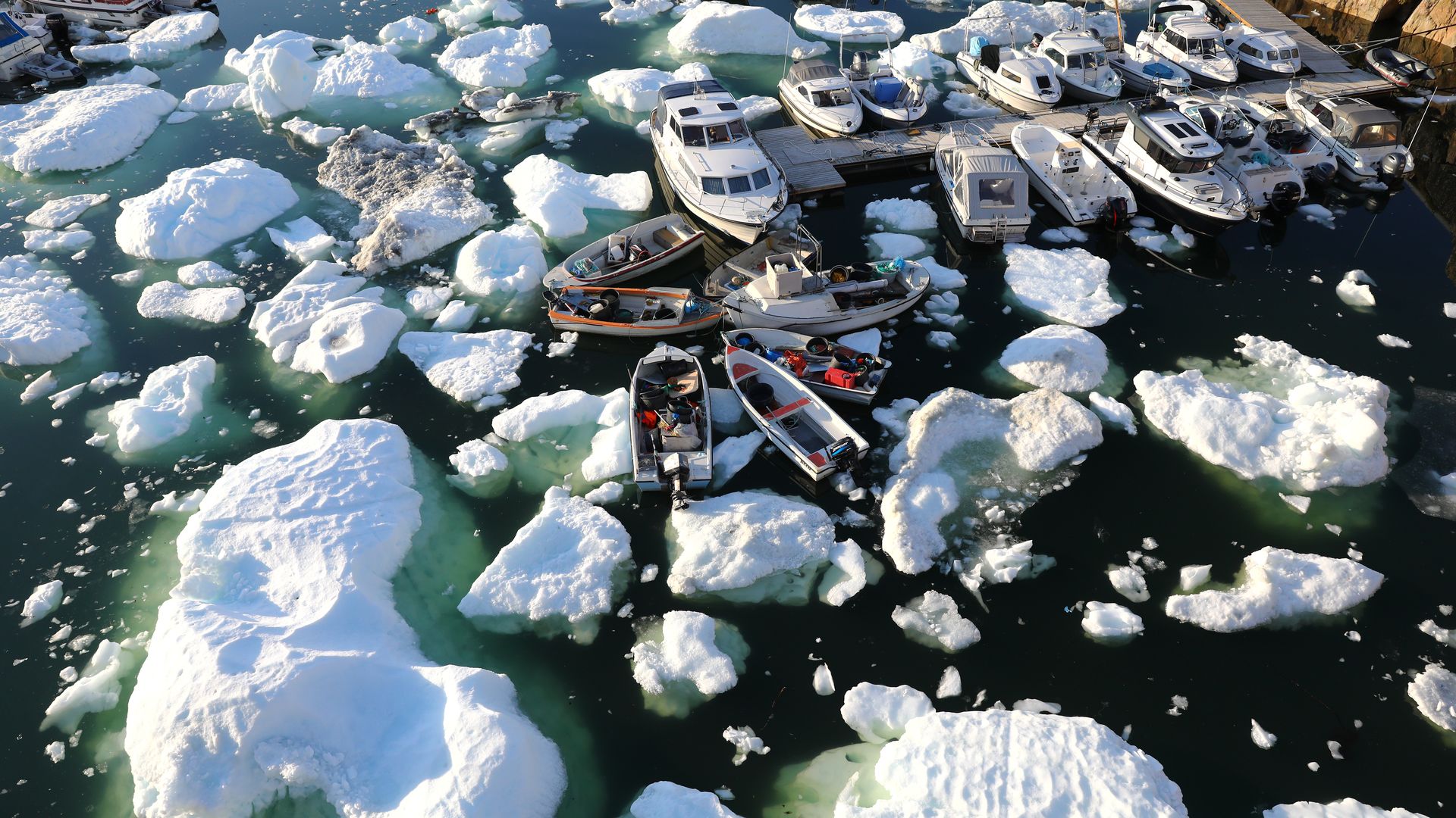 Boats among melting ice caps in Greenland
