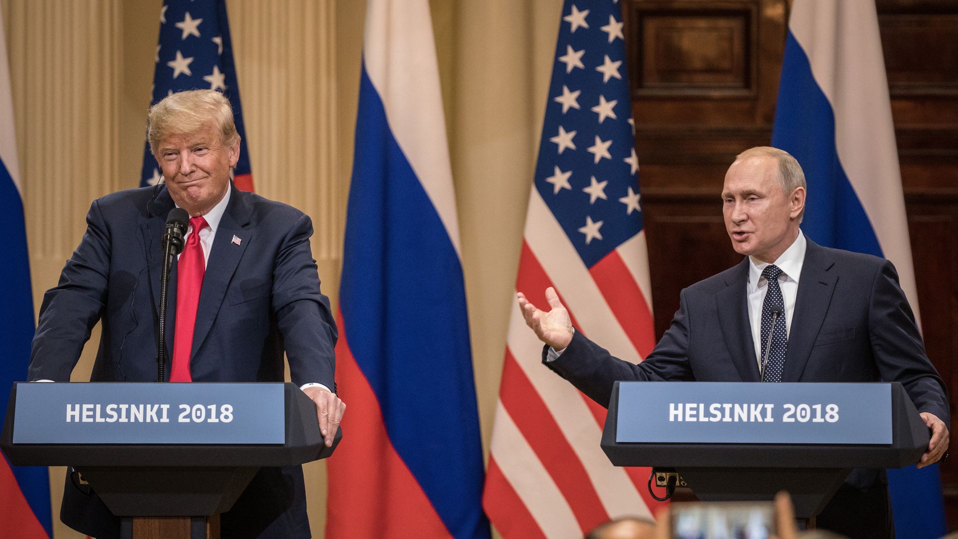 Trump and Putin in Helsinki at podiums speaking.