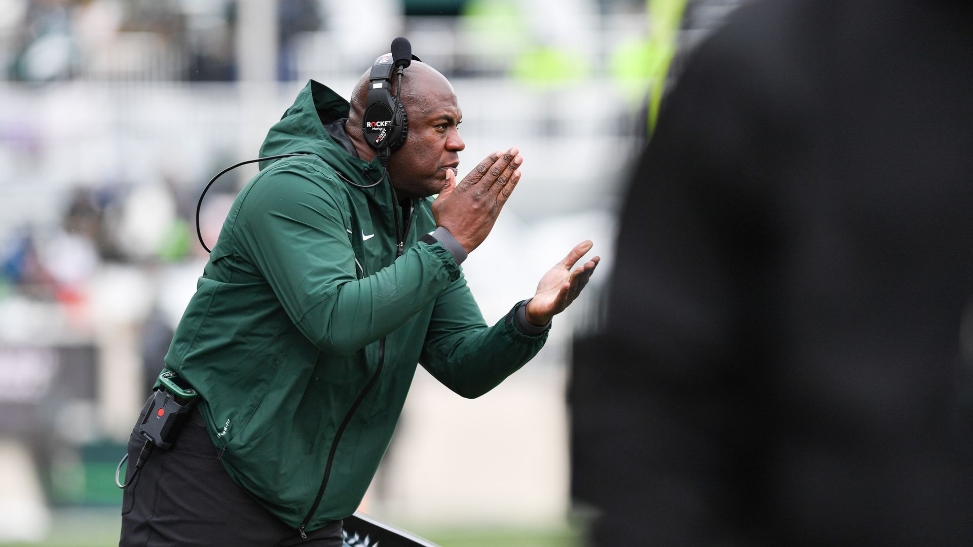 Michigan State Spartans head coach Mel Tucker implores his team to keep chopping