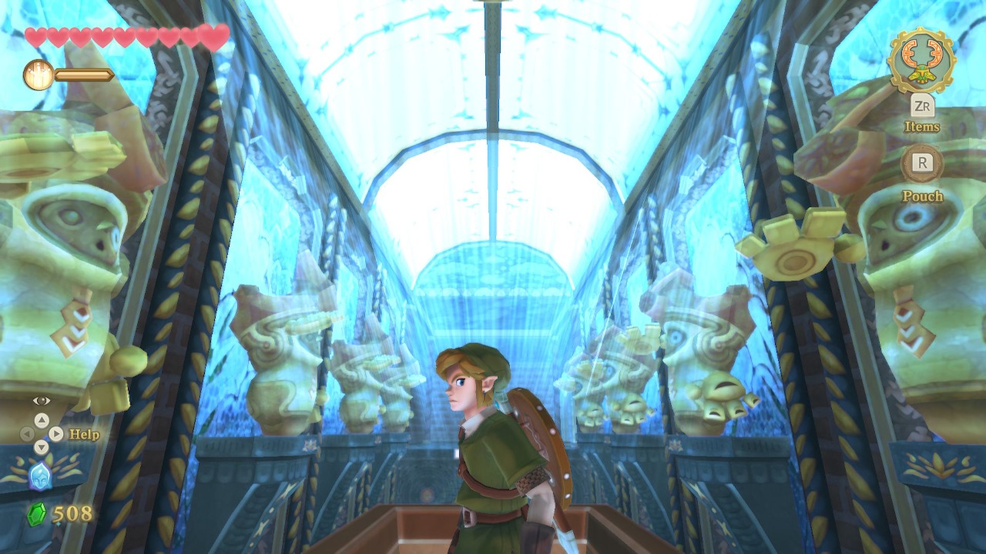 Video game screenshot of Zelda protagonist Link in a hallway lined with statues