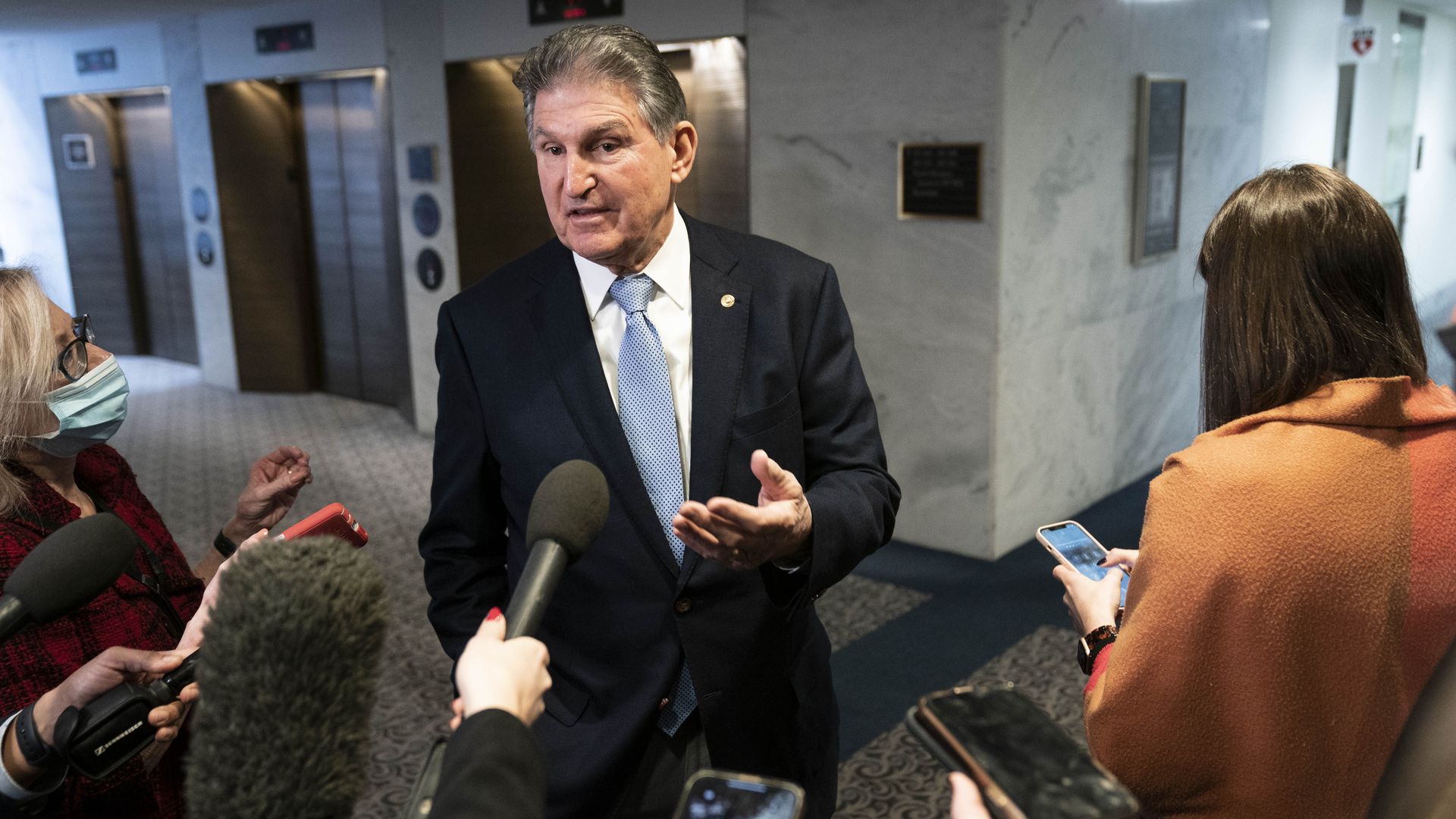 Sen. Joe Manchin is seen speaking with reporters on Monday.