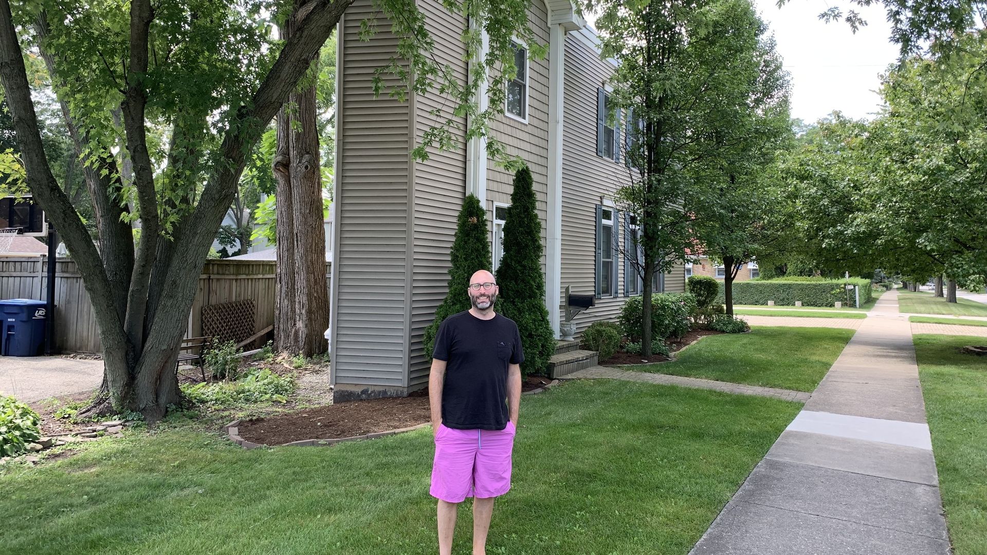 Guy in front of narrow house 
